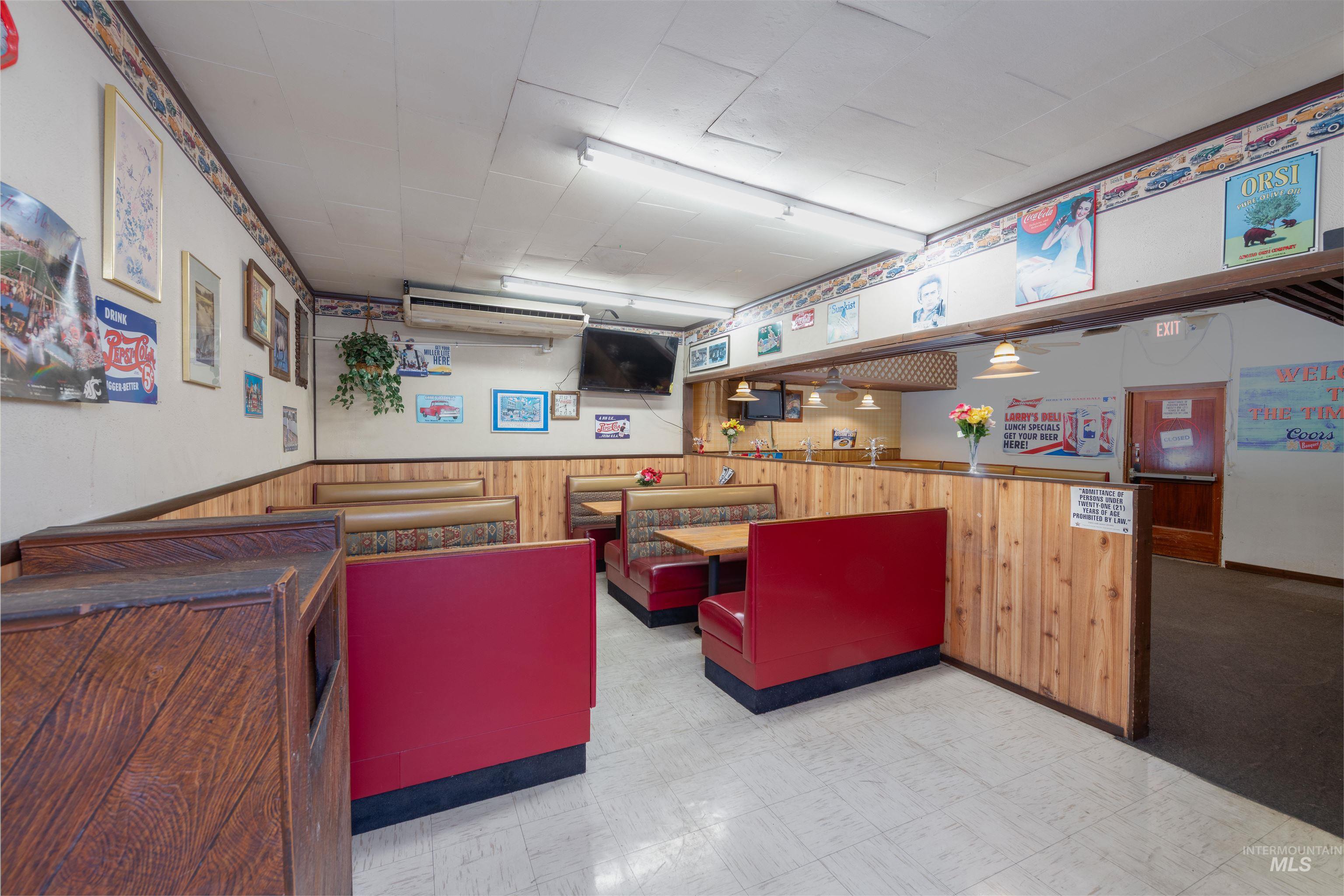 Interior space featuring wood walls, light flooring, and wainscoting
