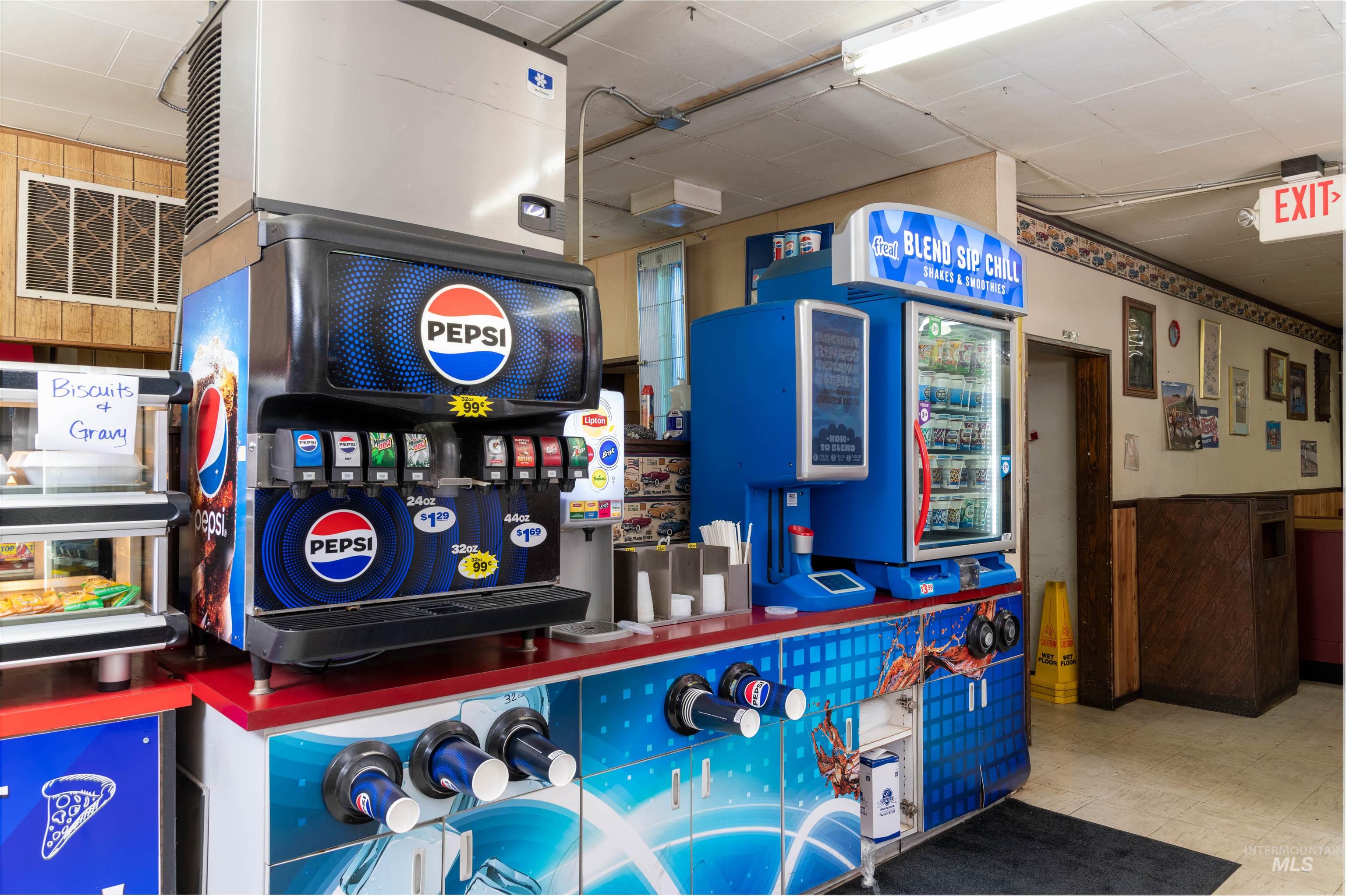 Game room featuring wooden walls, tile patterned floors, and wainscoting