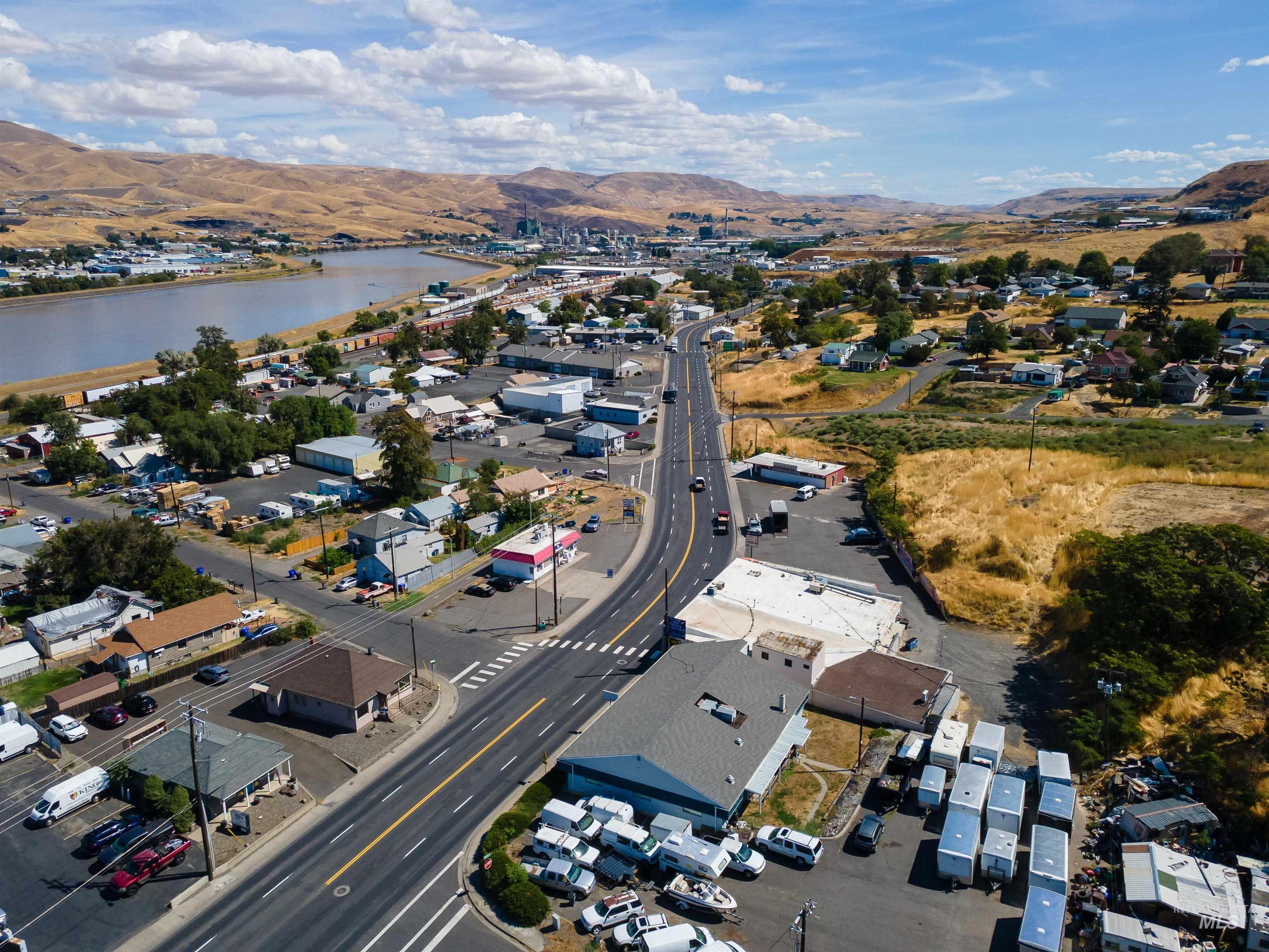 Aerial overview of property's location featuring nearby suburban area and a water and mountain view