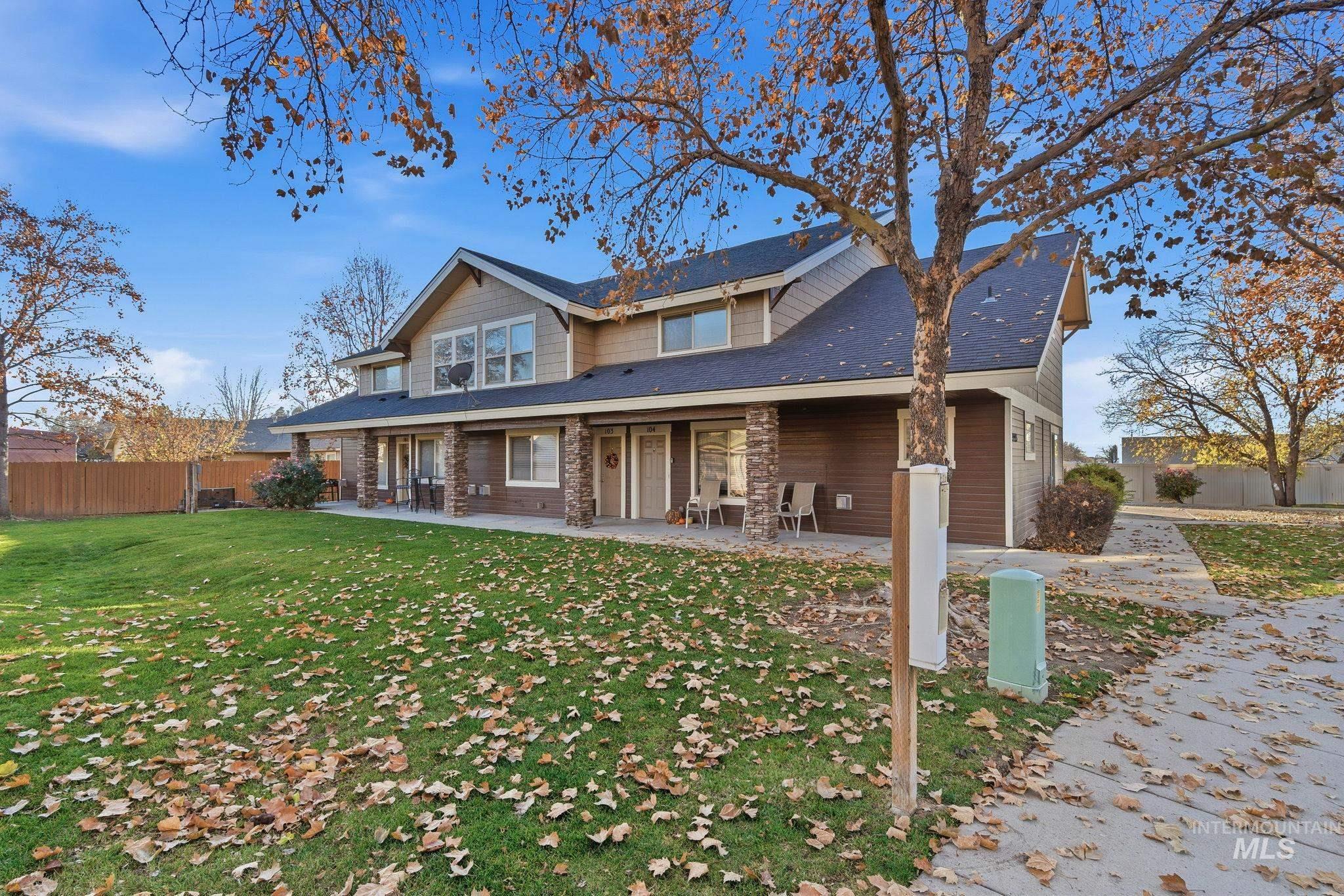 Rear view of property with stone siding and roof with shingles