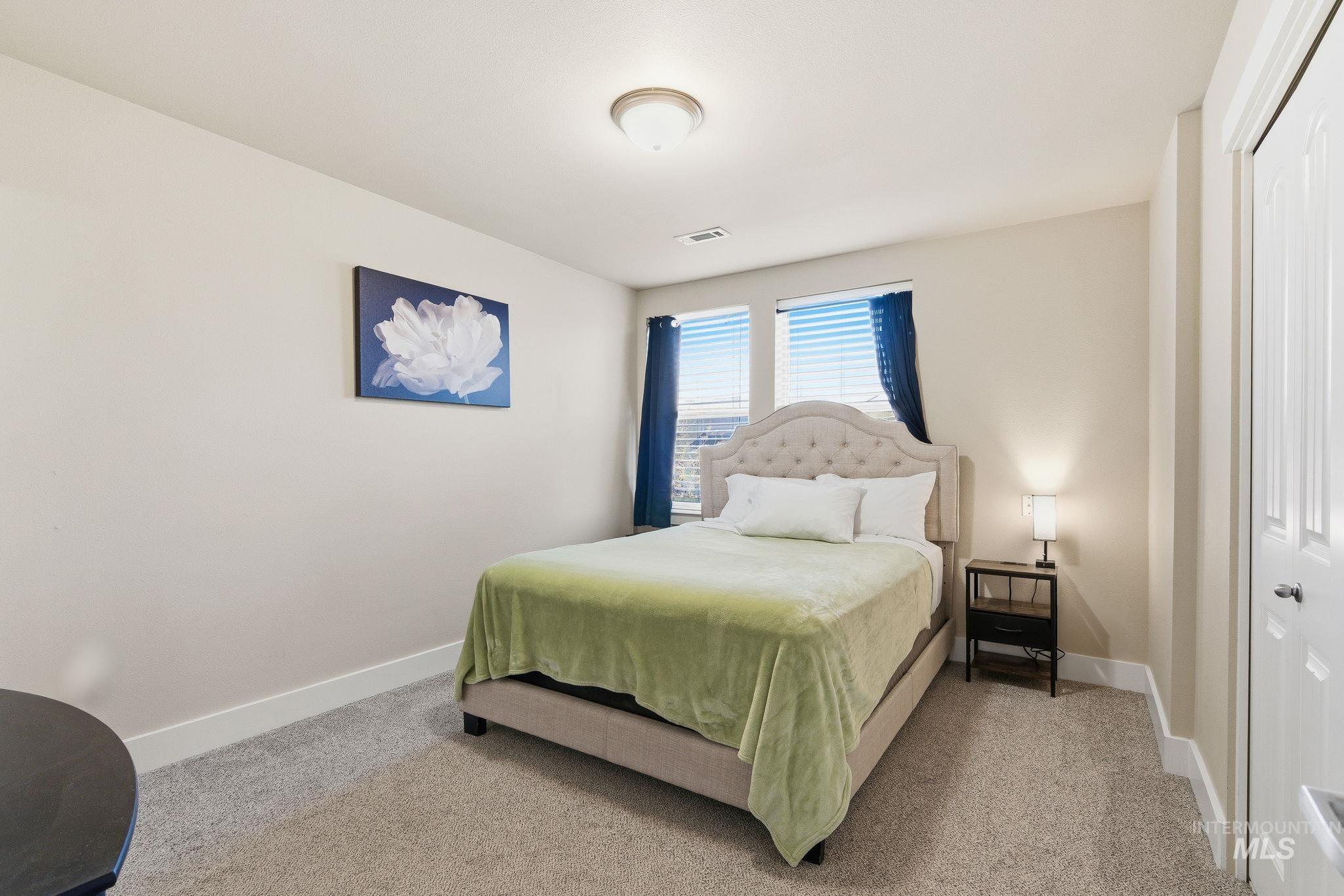 Bedroom featuring carpet flooring and a closet