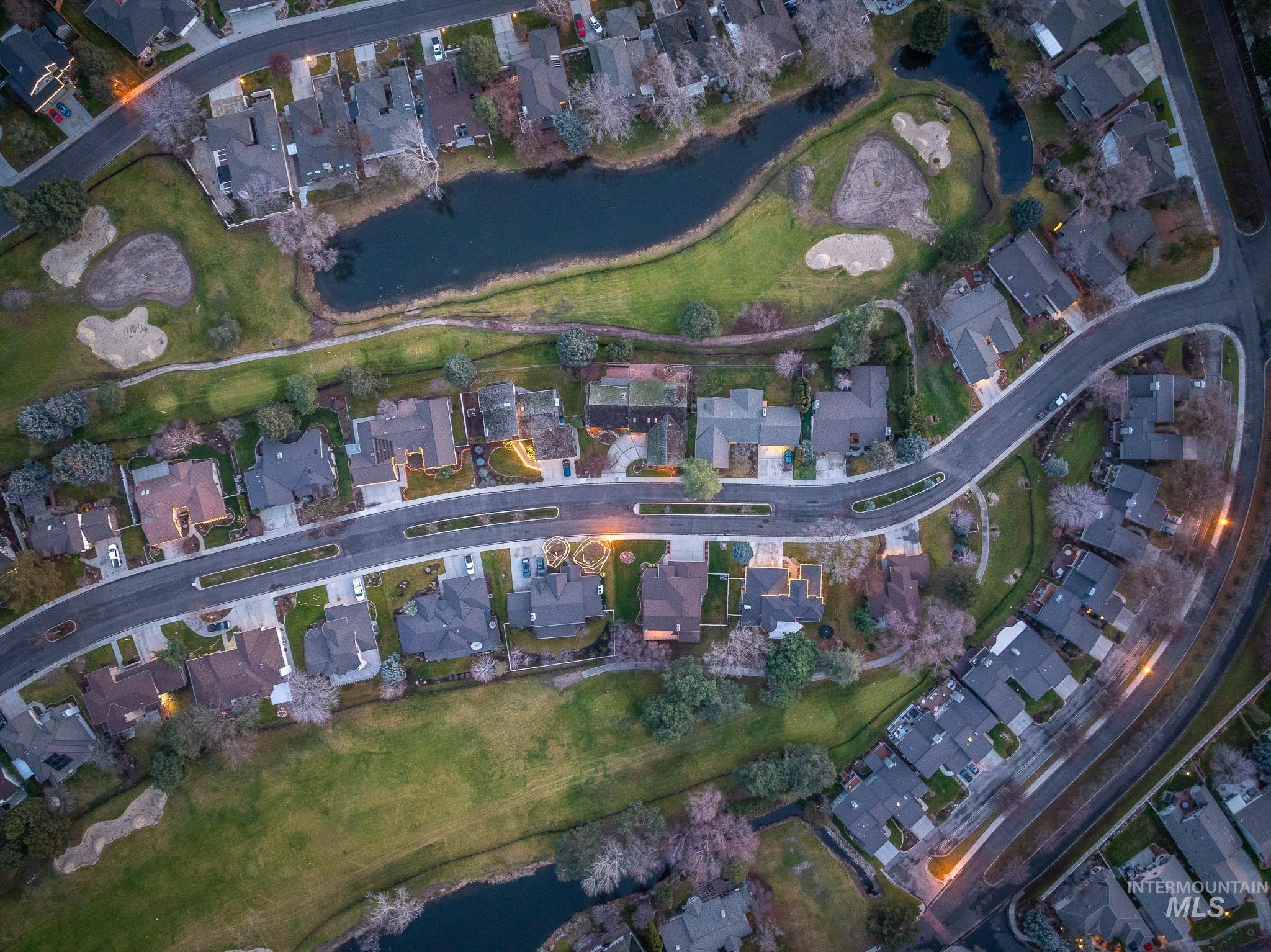 Aerial view of property's location featuring nearby suburban area and a large body of water