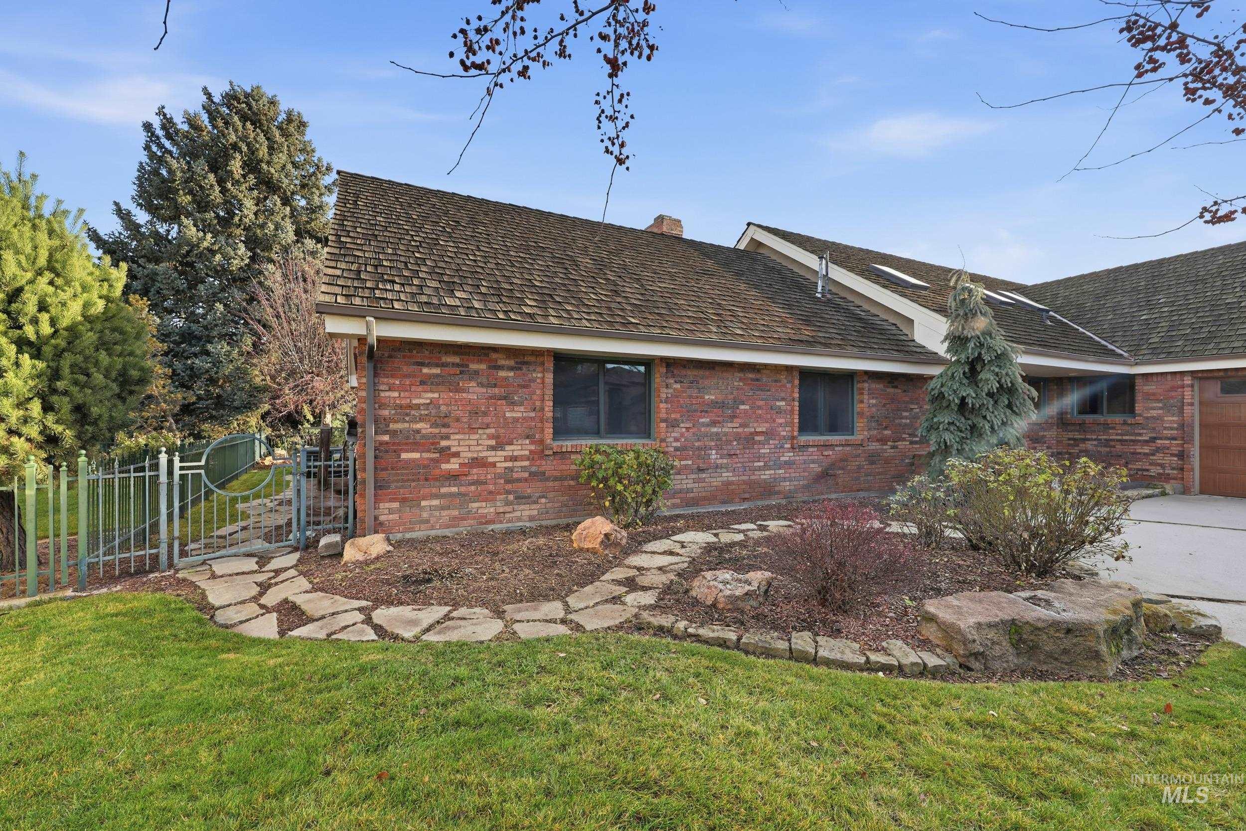 View of property exterior with brick siding and a chimney