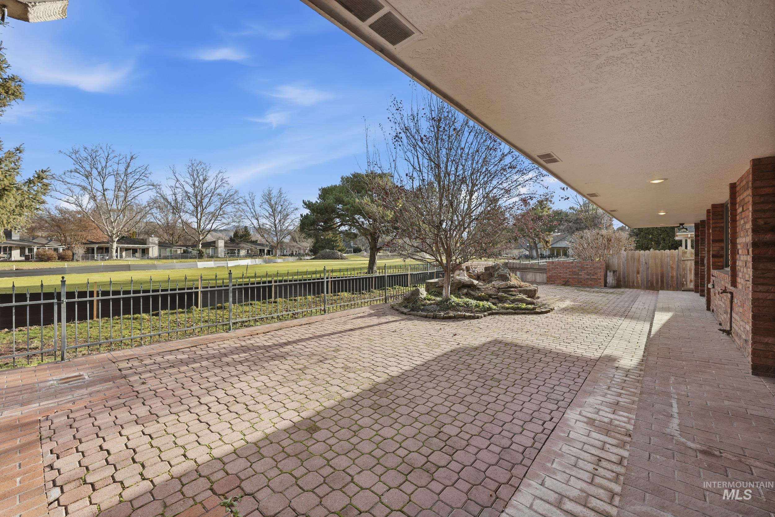 Fenced backyard with a patio and a residential view