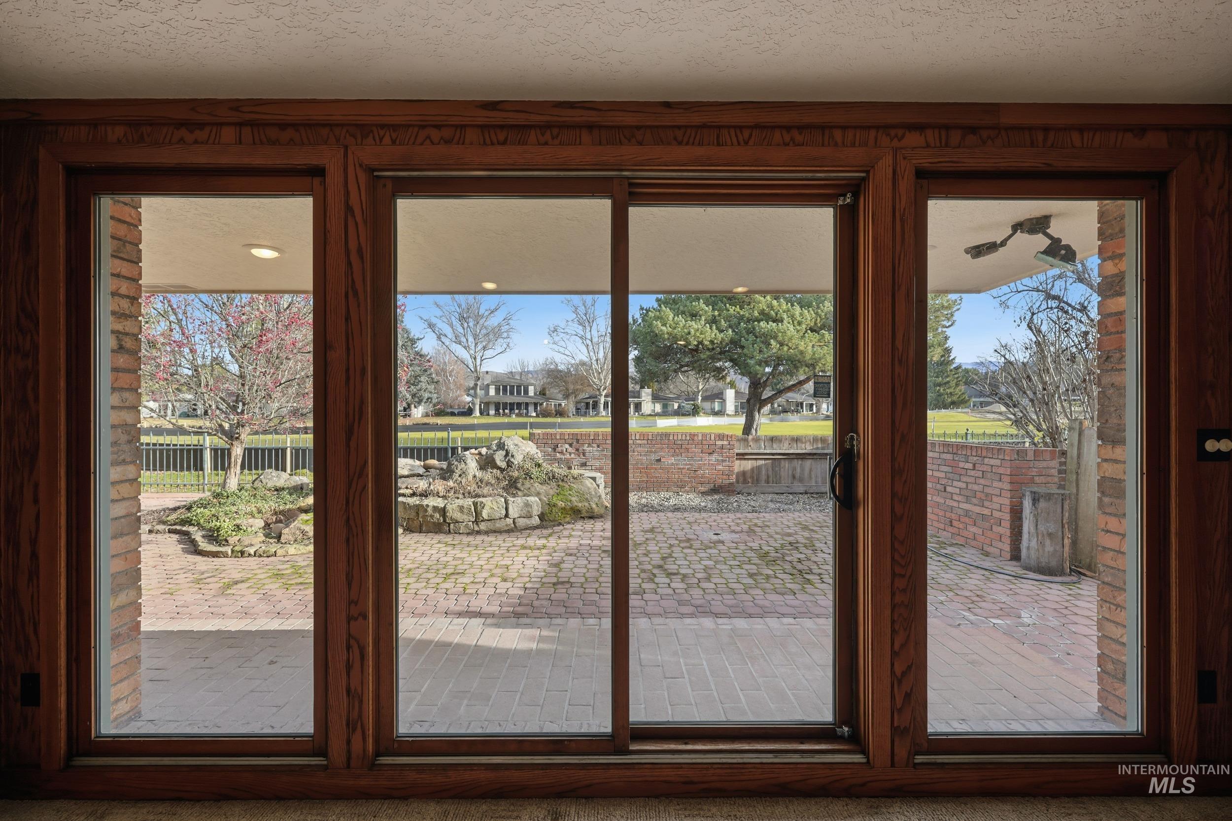 Doorway with a textured ceiling and carpet floors