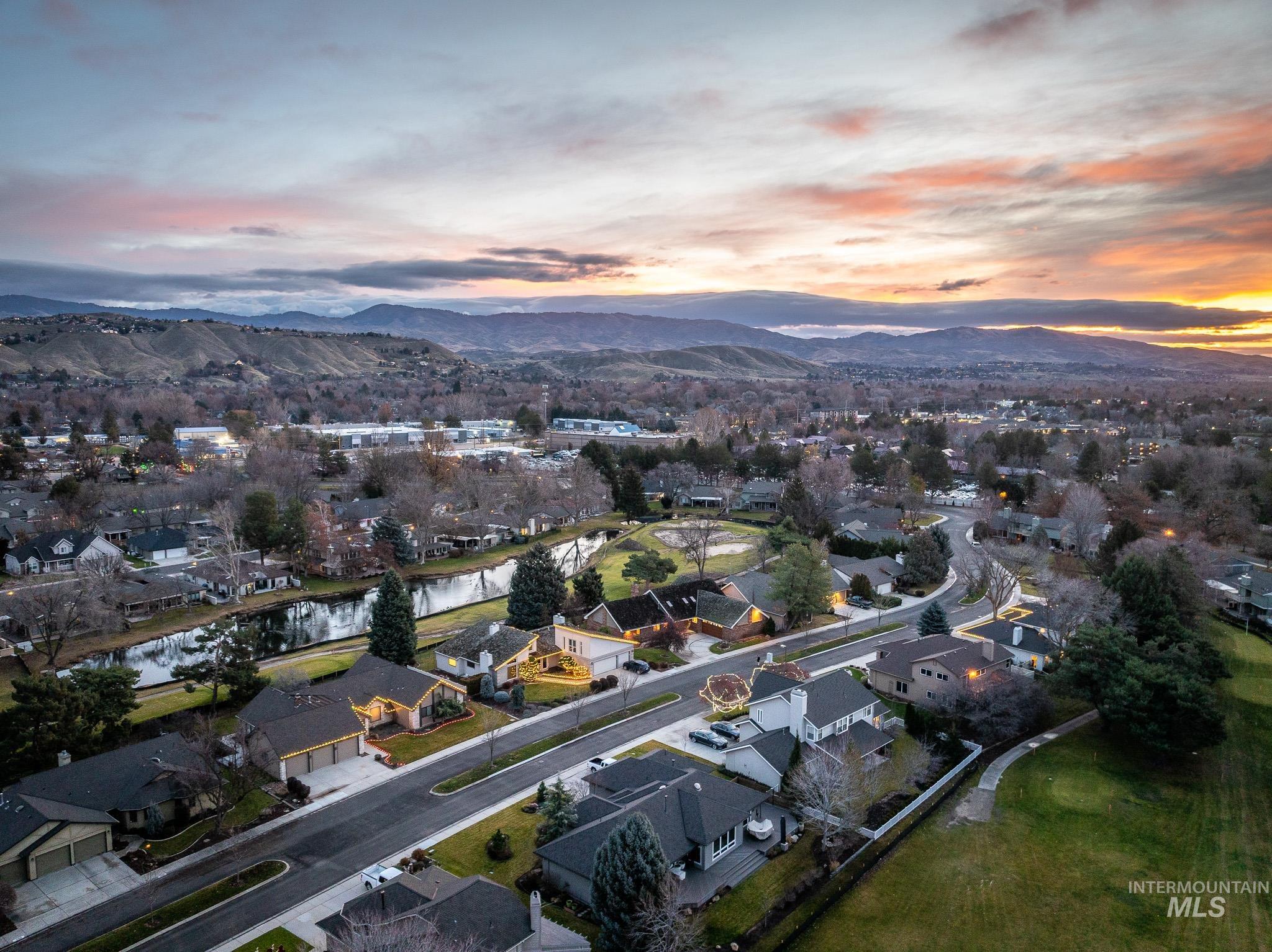 Aerial overview of property's location featuring nearby suburban area and a water and mountain view