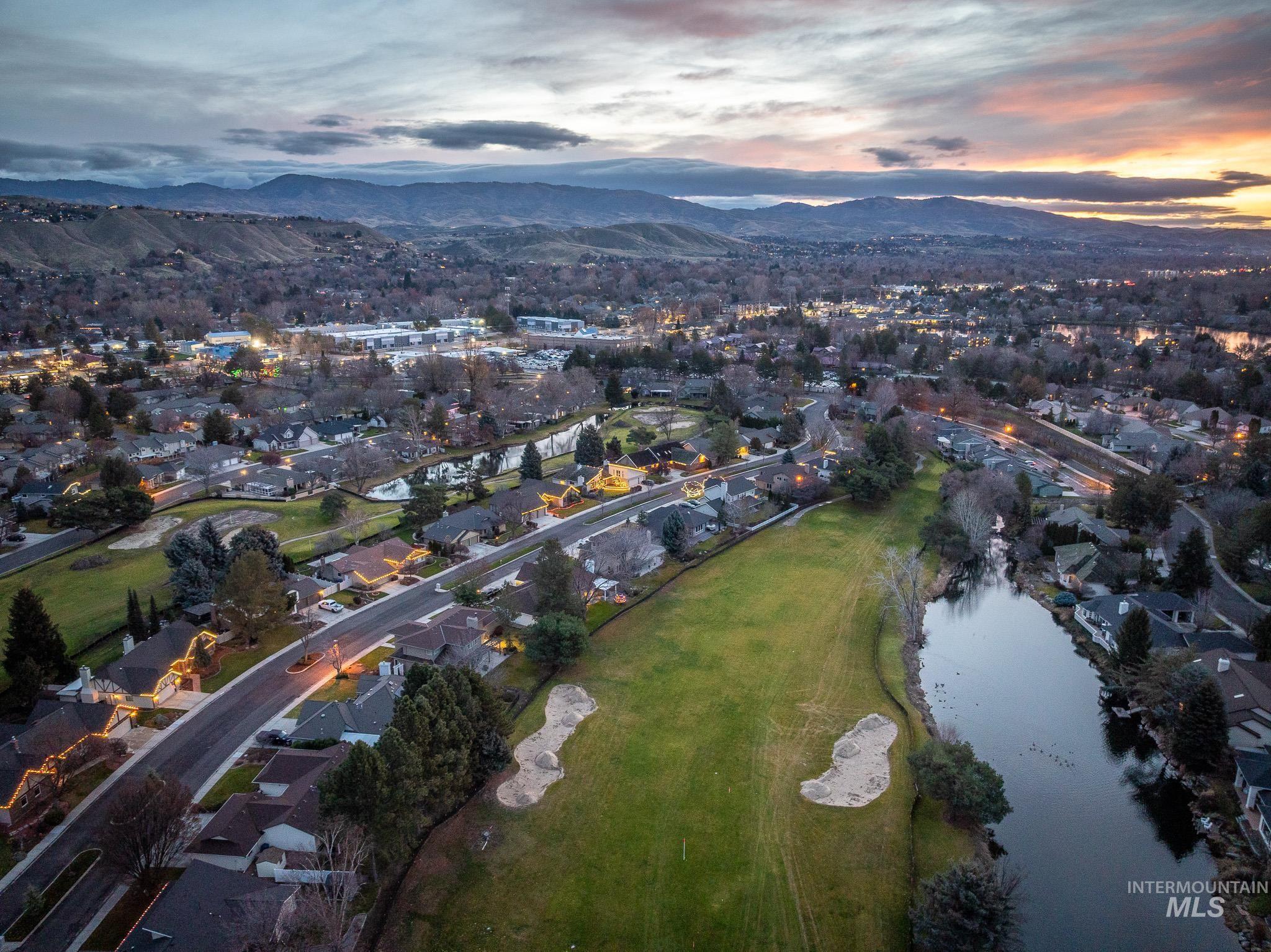 Aerial view at dusk of a water and mountain view and a residential view