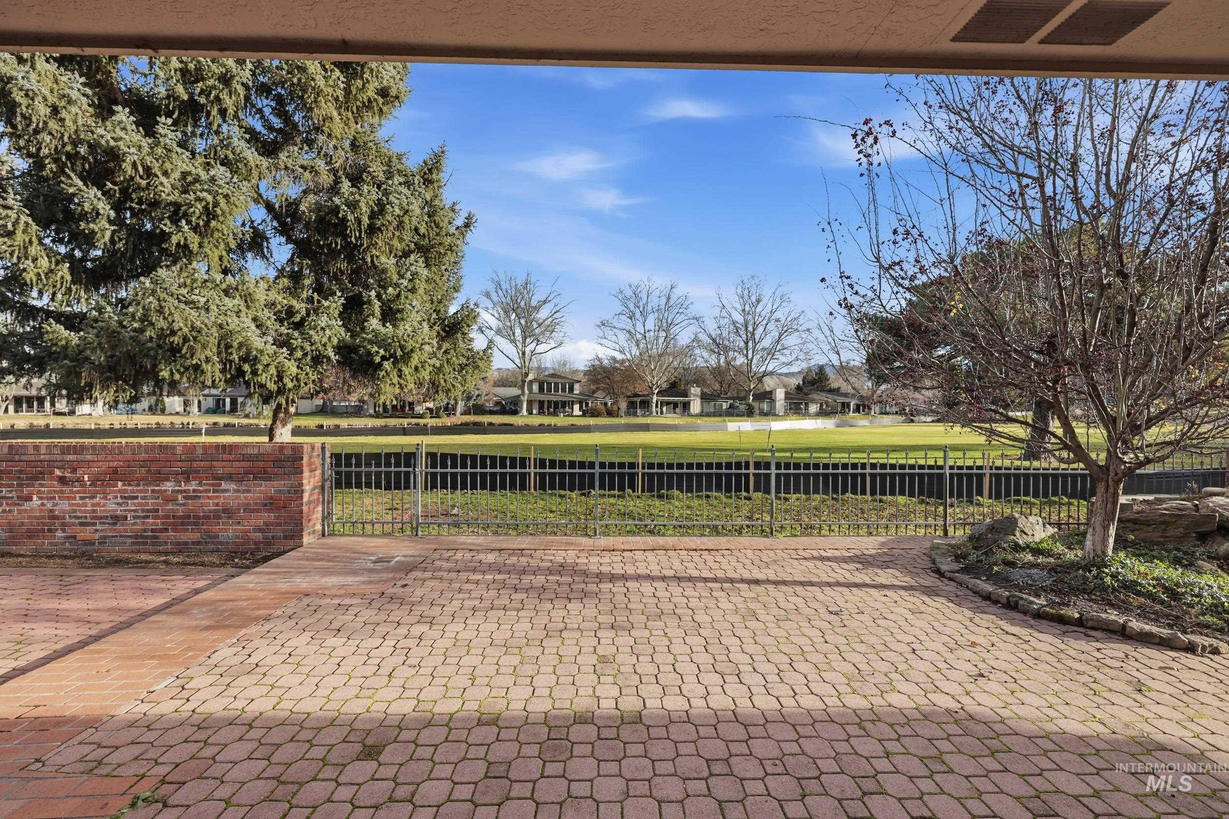 View of patio with a gate and a residential view