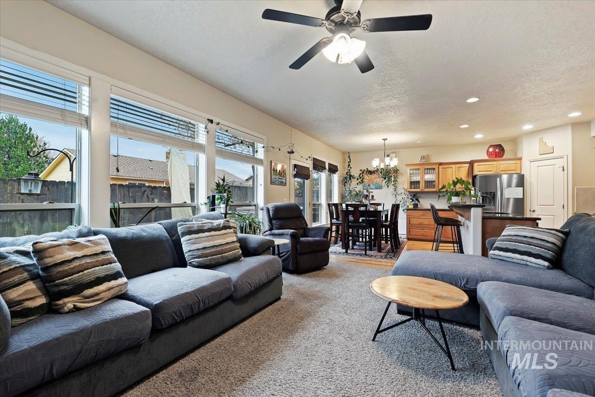 Living area featuring recessed lighting, a textured ceiling, and a ceiling fan