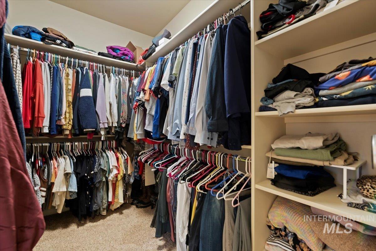 Walk in closet featuring light carpet