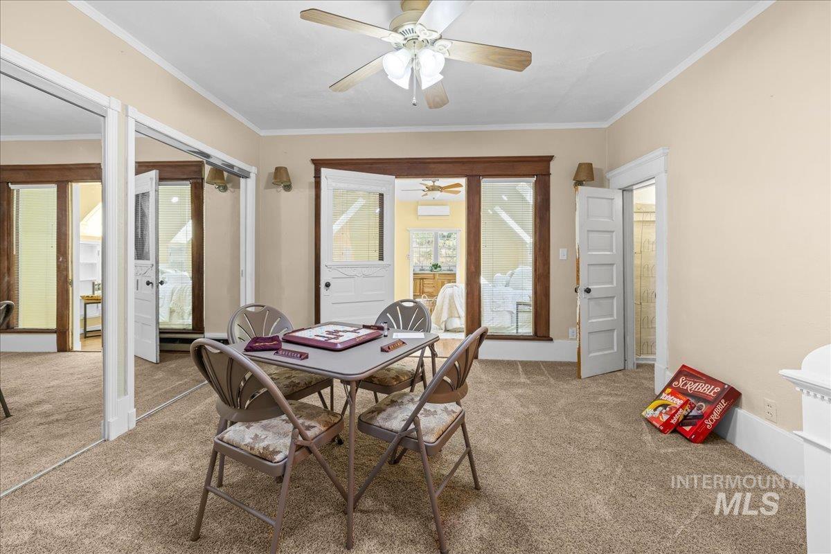 Carpeted family space with ornamental molding