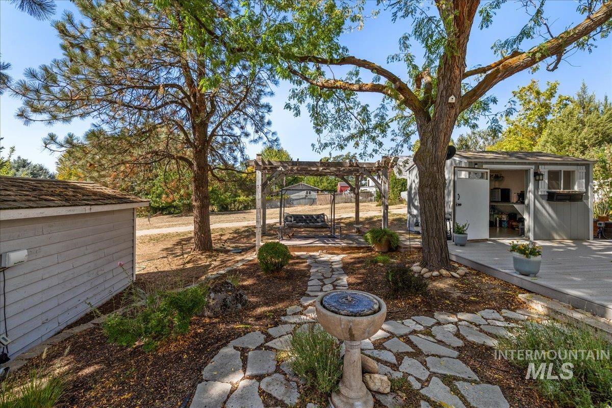 With a patio area, a pergola, a storage shed, and a wooden deck