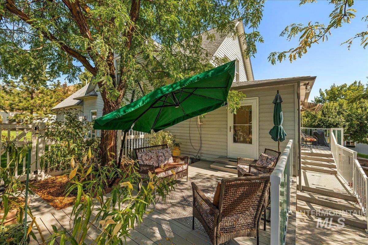 View of property exterior featuring a wooden deck and outdoor lounge area
