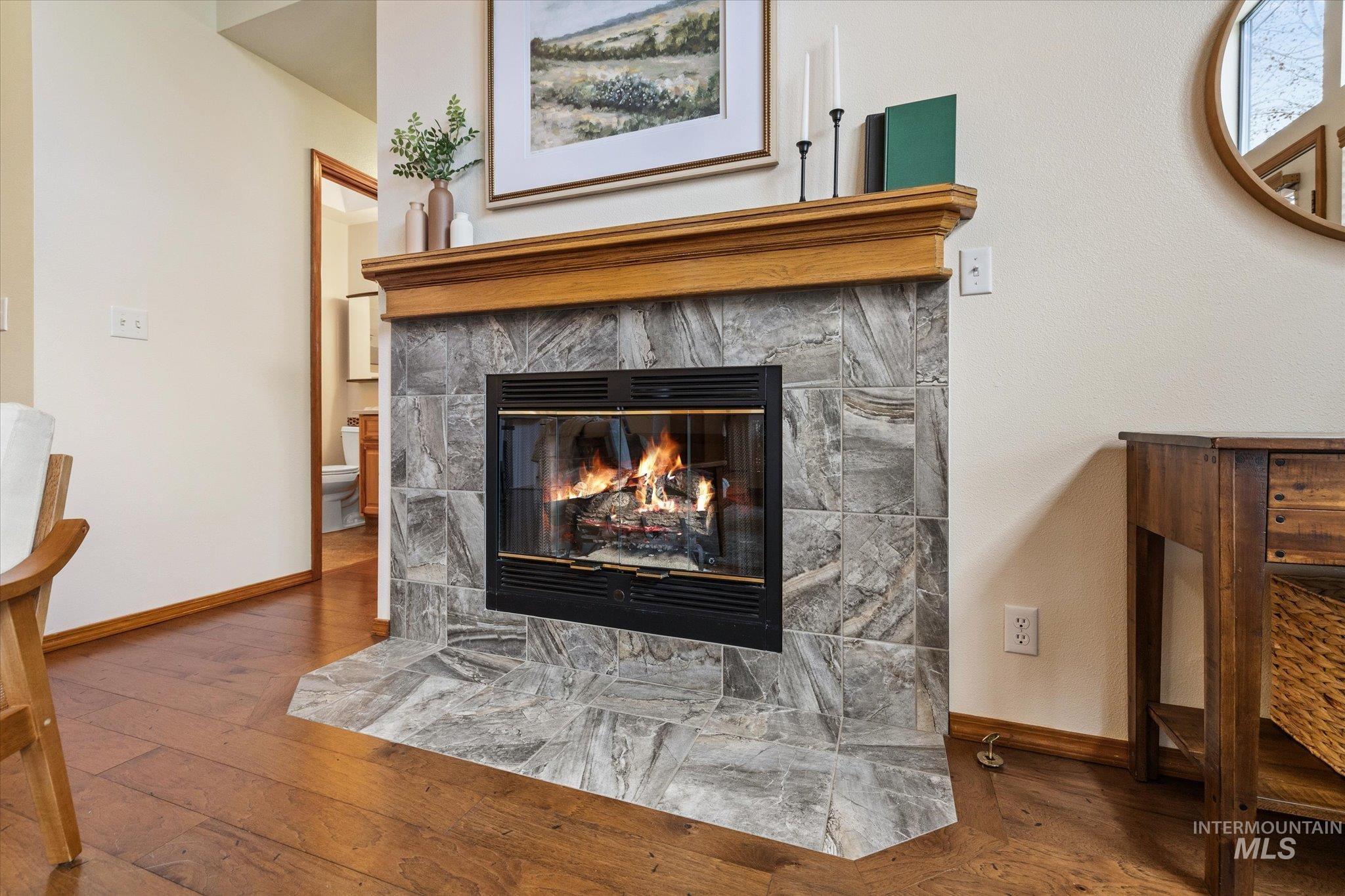 Detailed view of a fireplace and wood finished floors