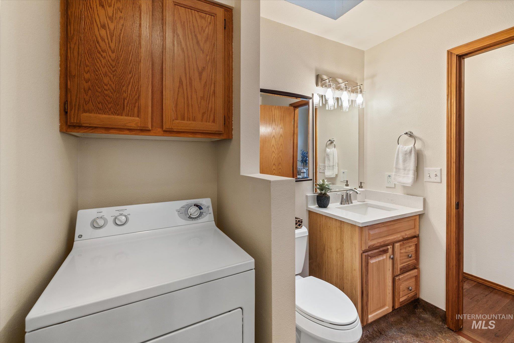 Half bathroom featuring washer / clothes dryer and vanity