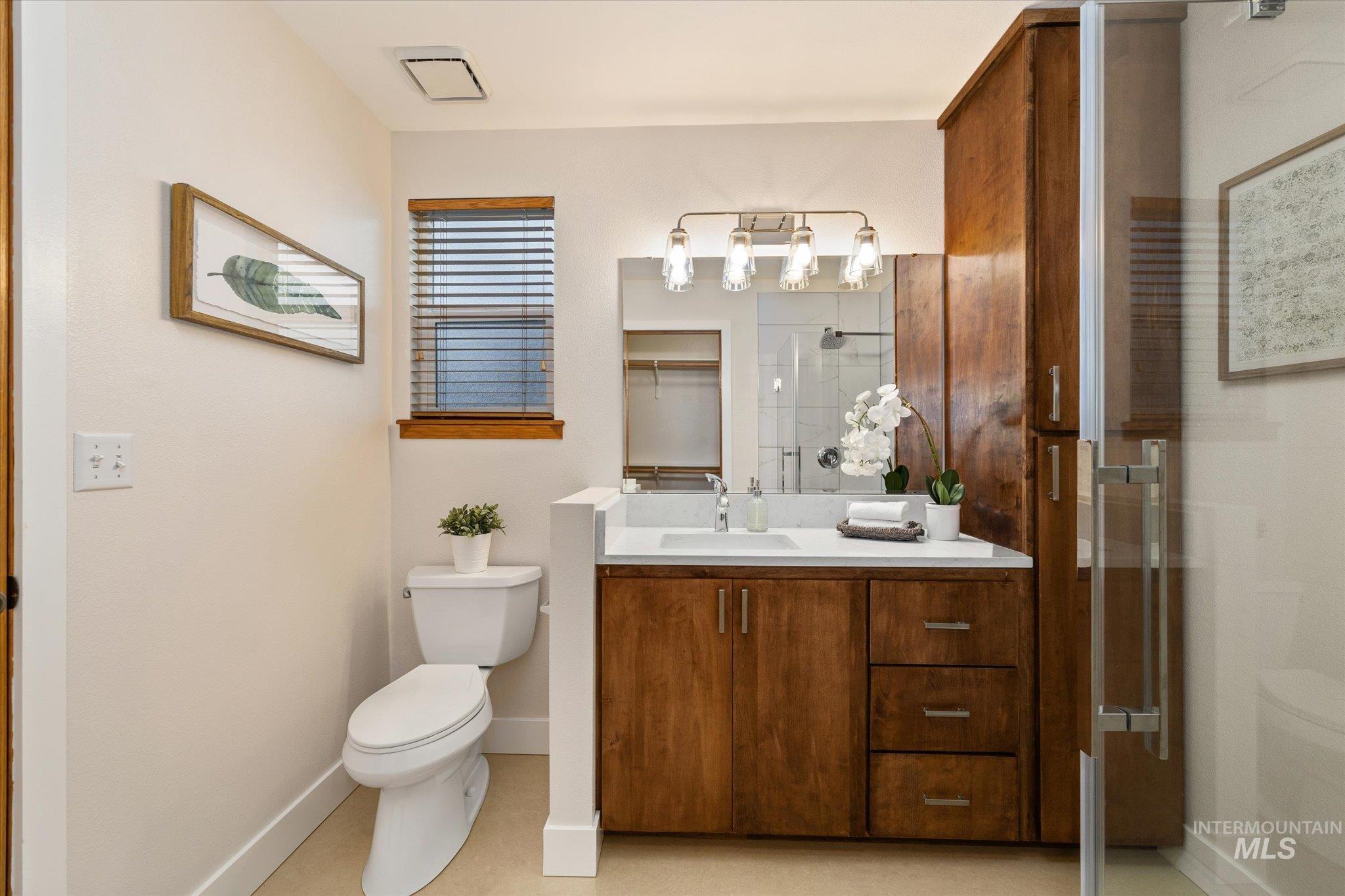 Bathroom with vanity and a shower stall