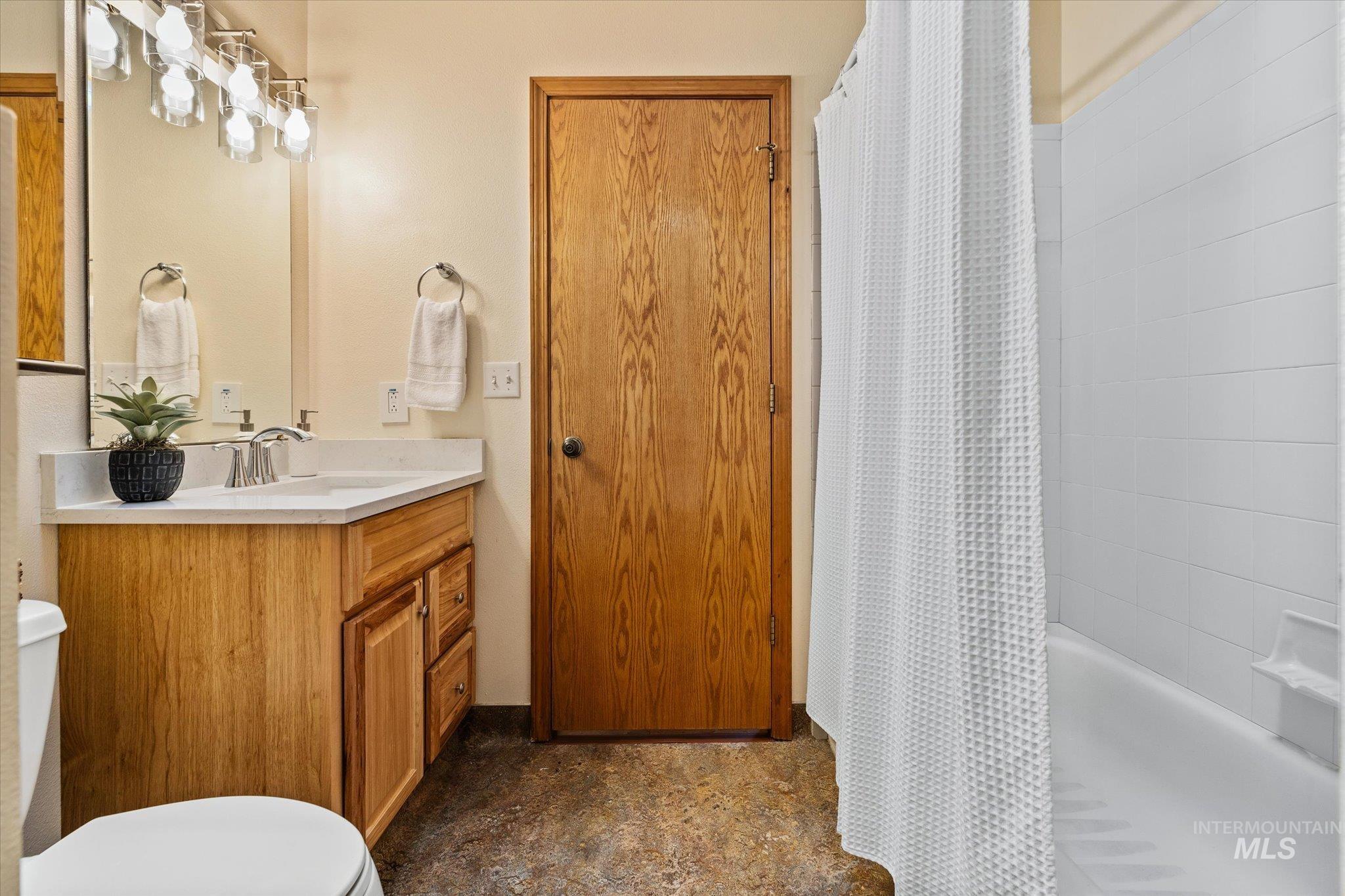 Bathroom with vanity and shower / bath combo