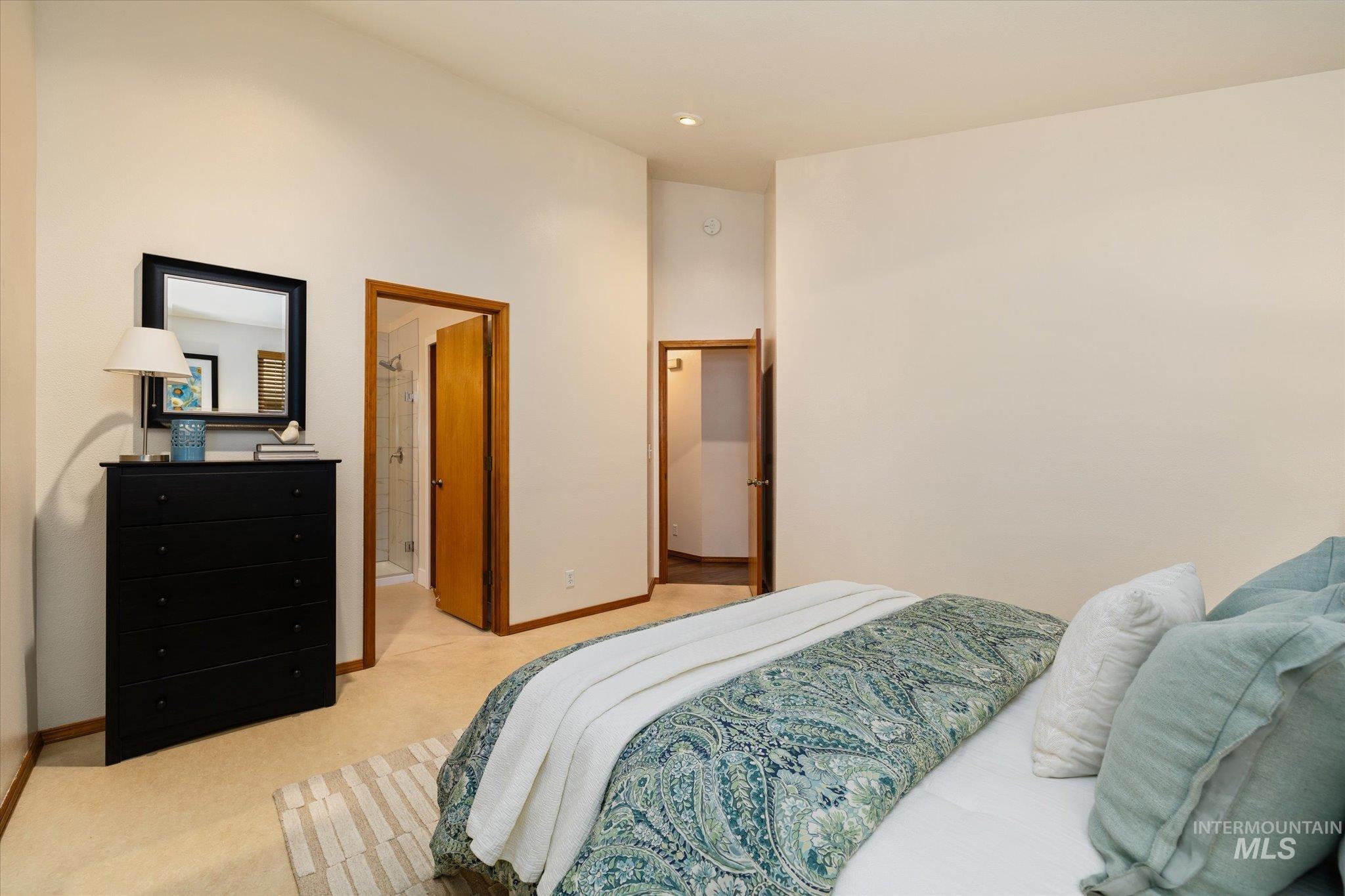 Bedroom with light carpet and baseboards