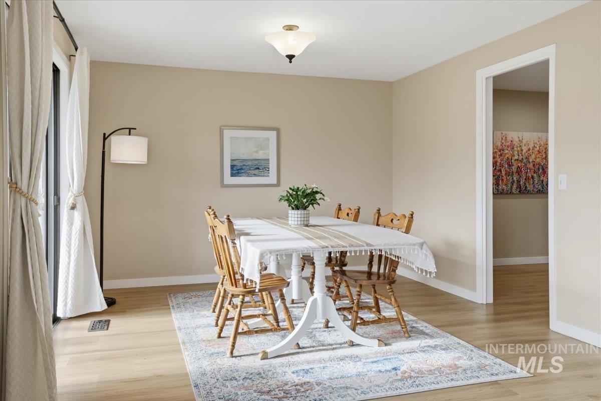 Dining area with light wood-style floors