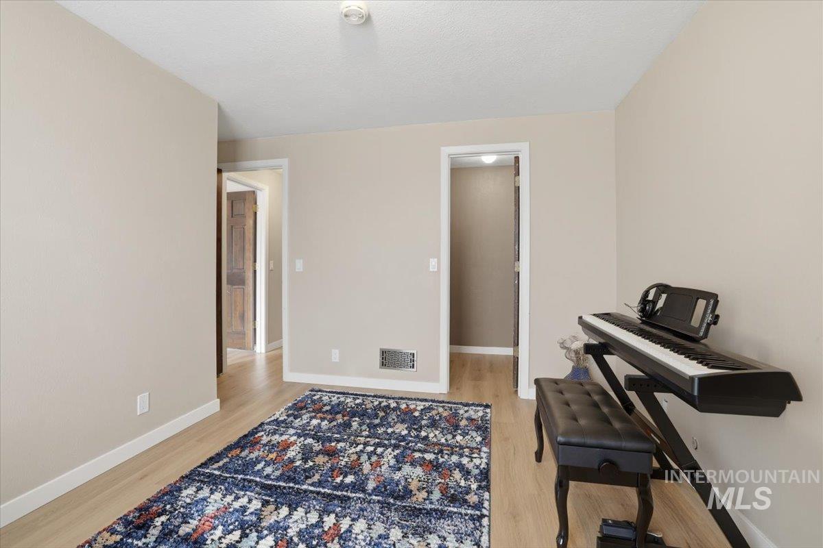 Sitting room with baseboards and light wood finished floors