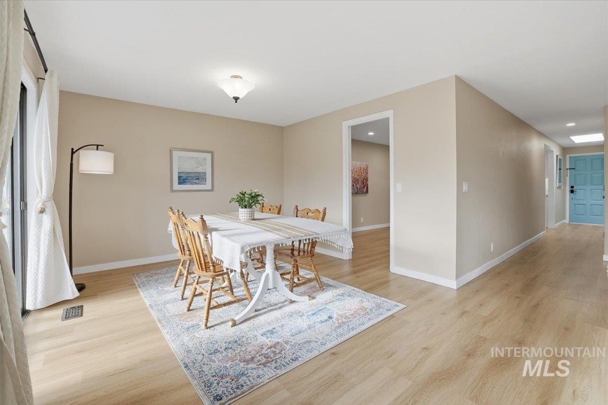 Dining room with baseboards and light wood-style flooring