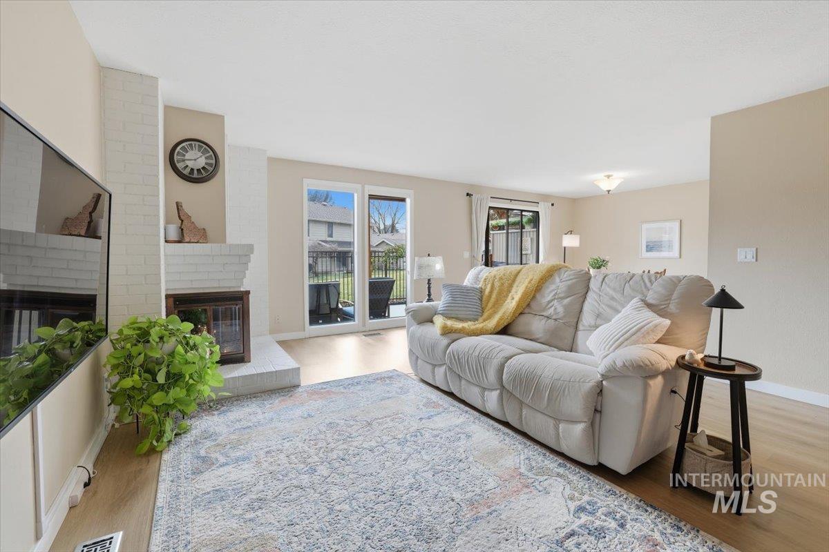 Living area featuring a fireplace and wood finished floors
