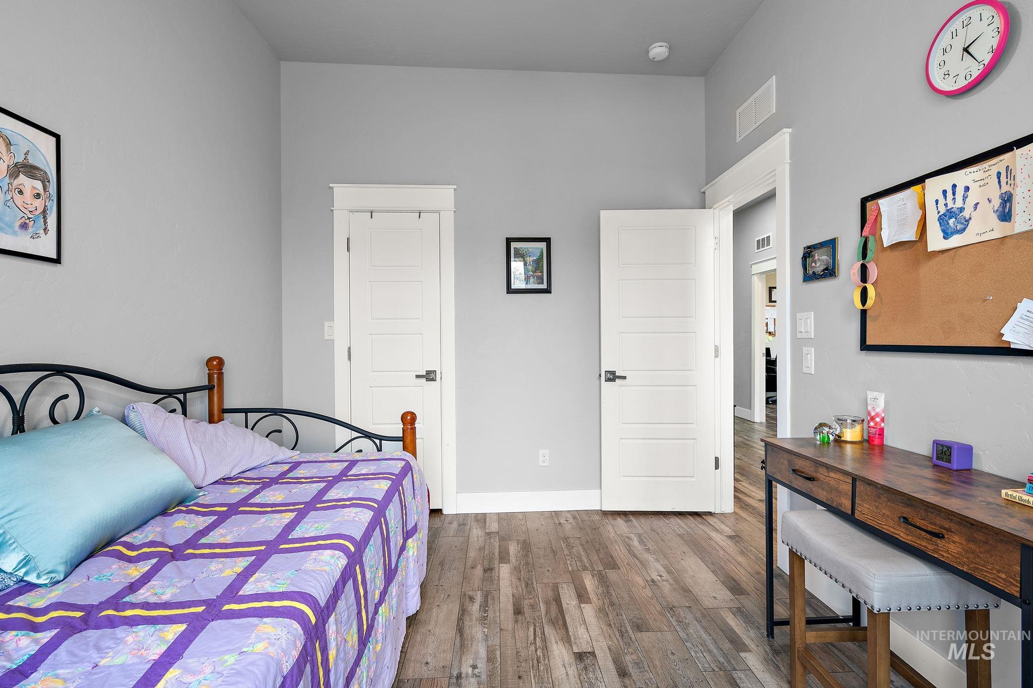 Bedroom with baseboards and wood-type flooring