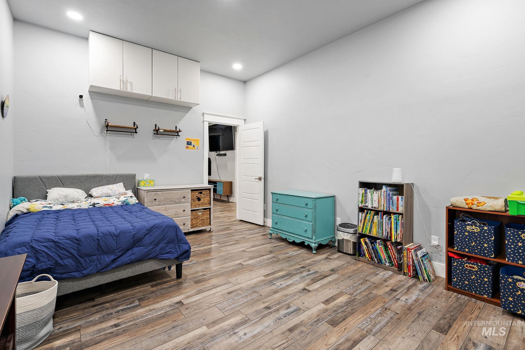 Bedroom featuring light wood finished floors and recessed lighting