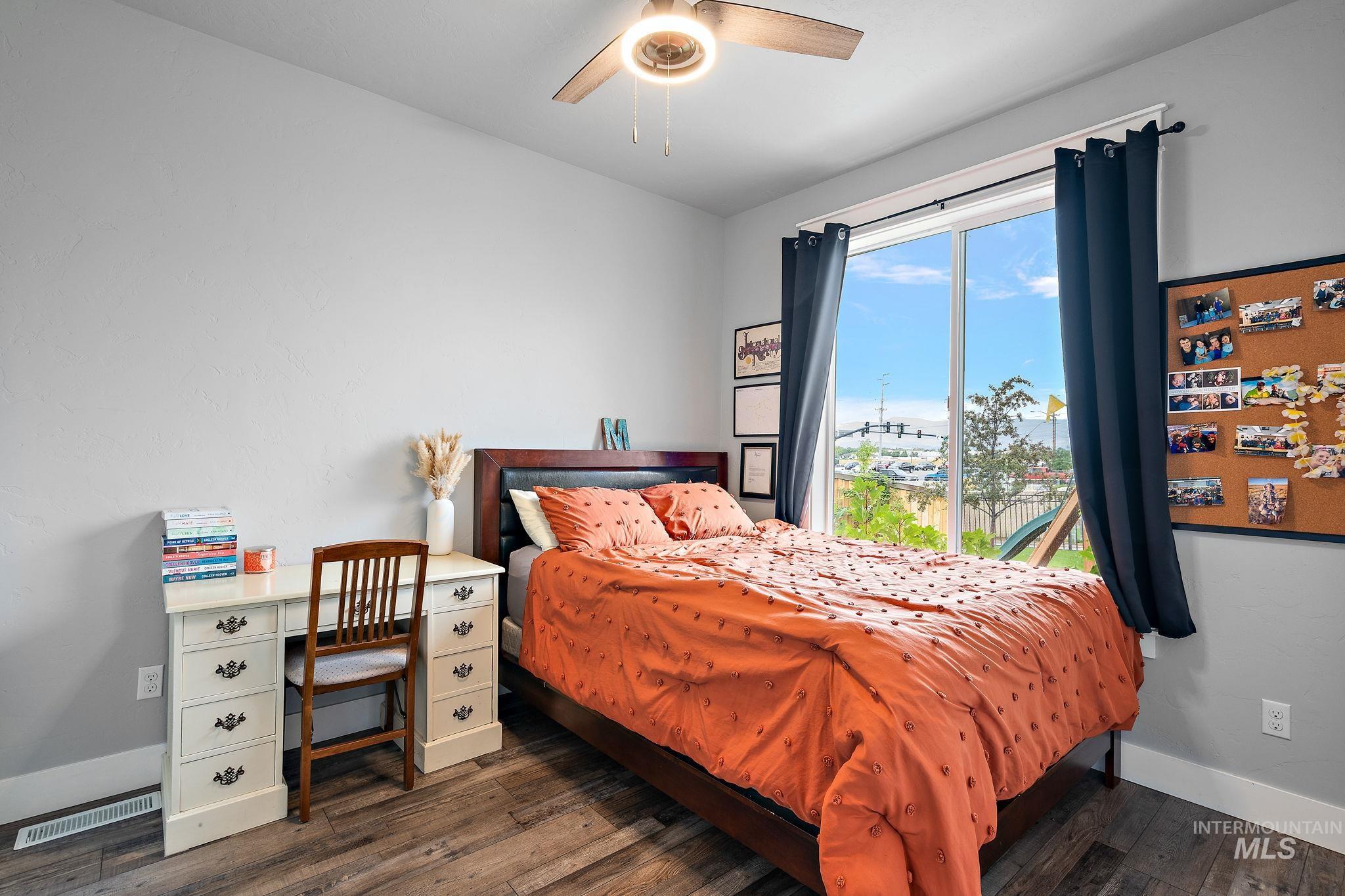 Bedroom featuring dark wood finished floors and ceiling fan