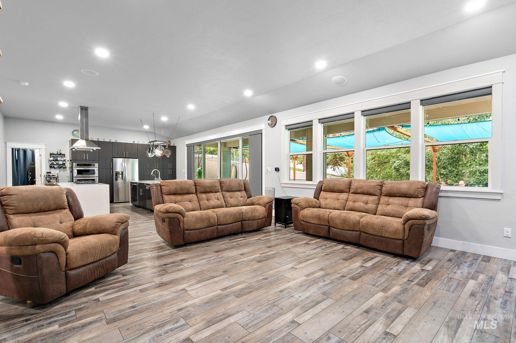 Living room with recessed lighting and light wood-style floors
