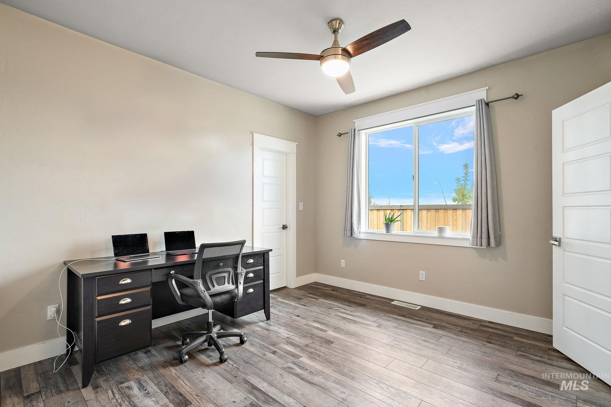 Office area featuring hardwood / wood-style flooring and ceiling fan