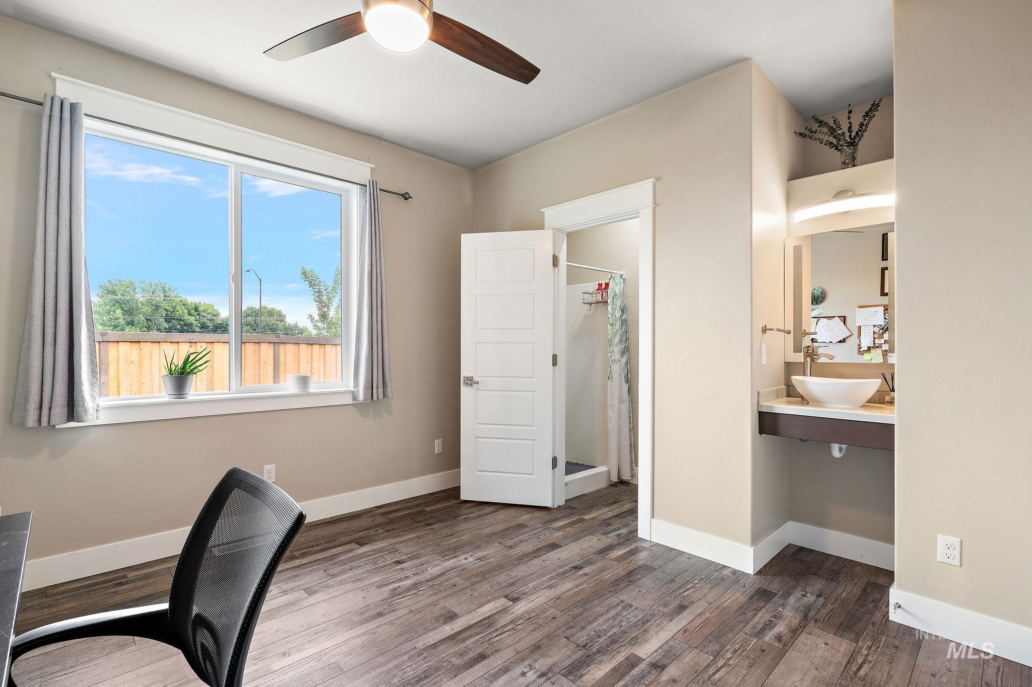 Office area featuring baseboards and dark wood finished floors
