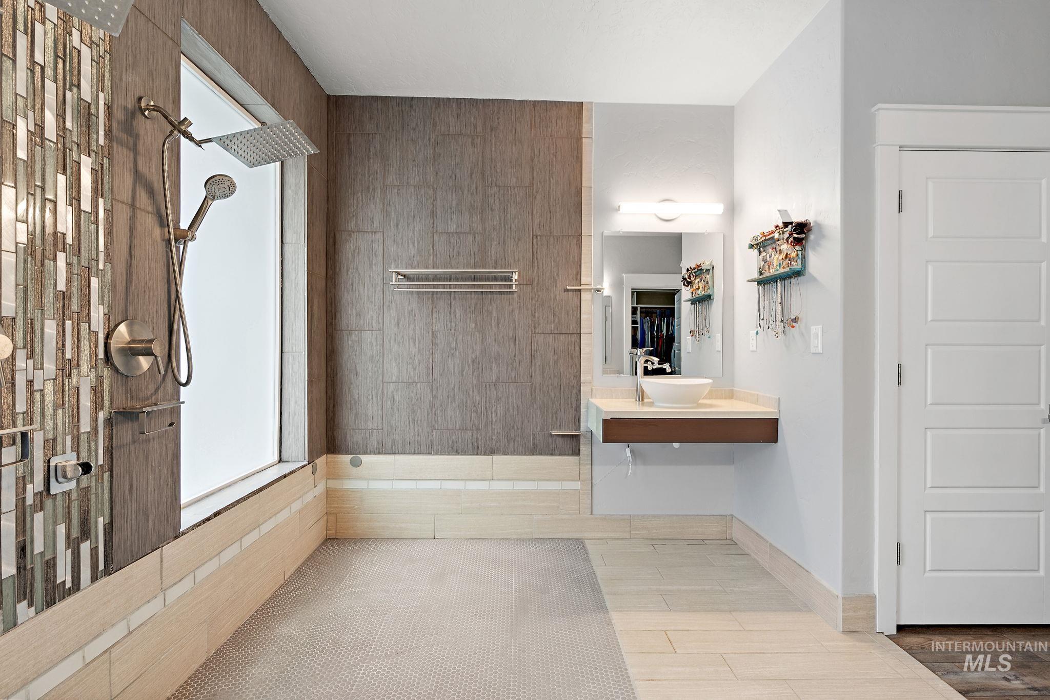 Full bath with a walk in shower and light wood-style flooring