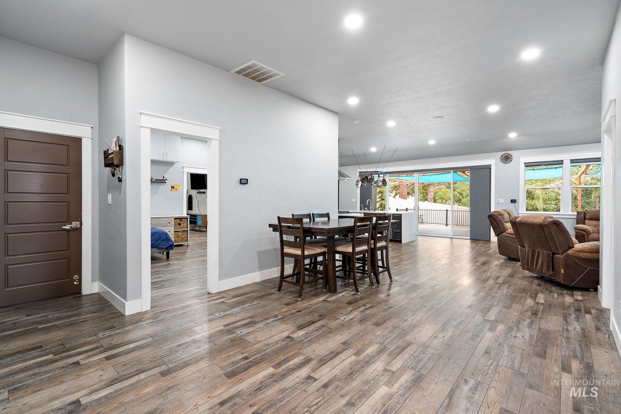 Dining area featuring recessed lighting and dark wood-type flooring