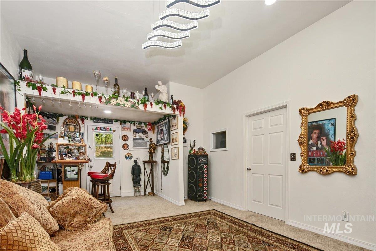 Sitting room featuring carpet floors and baseboards
