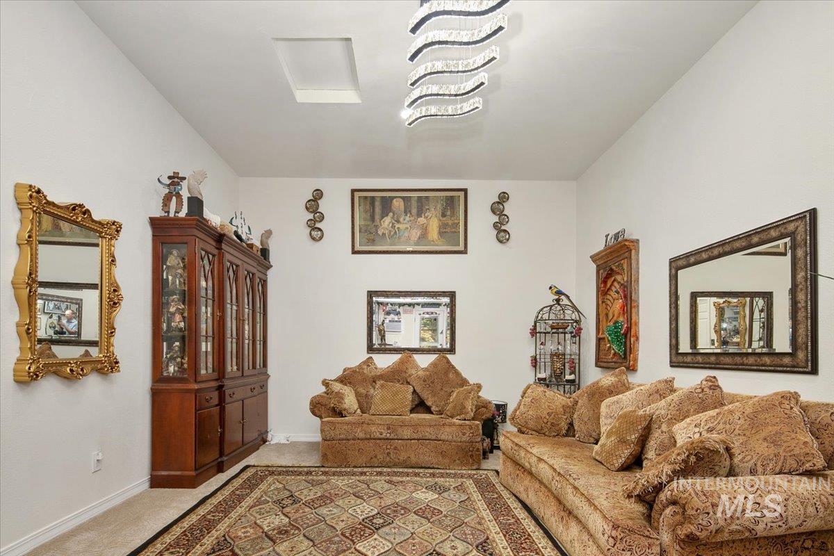 Living room featuring light carpet and baseboards