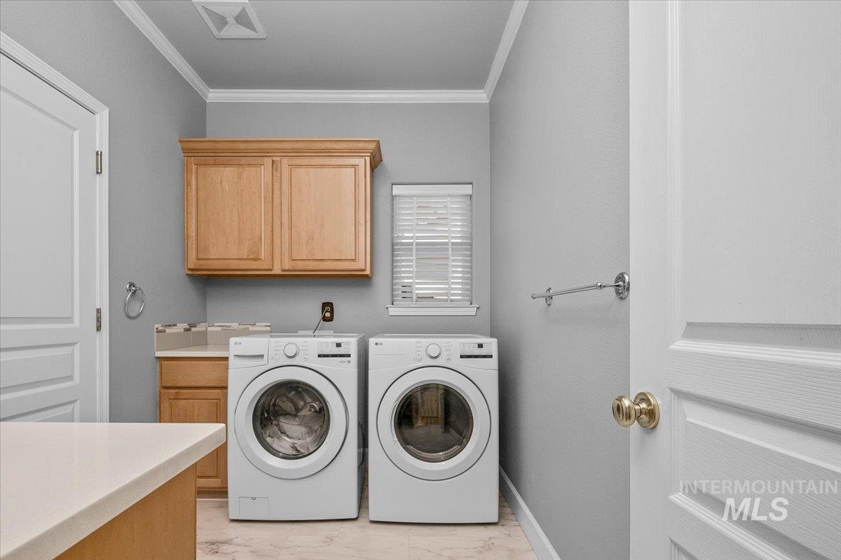 Washroom with ornamental molding, independent washer and dryer, and cabinet space