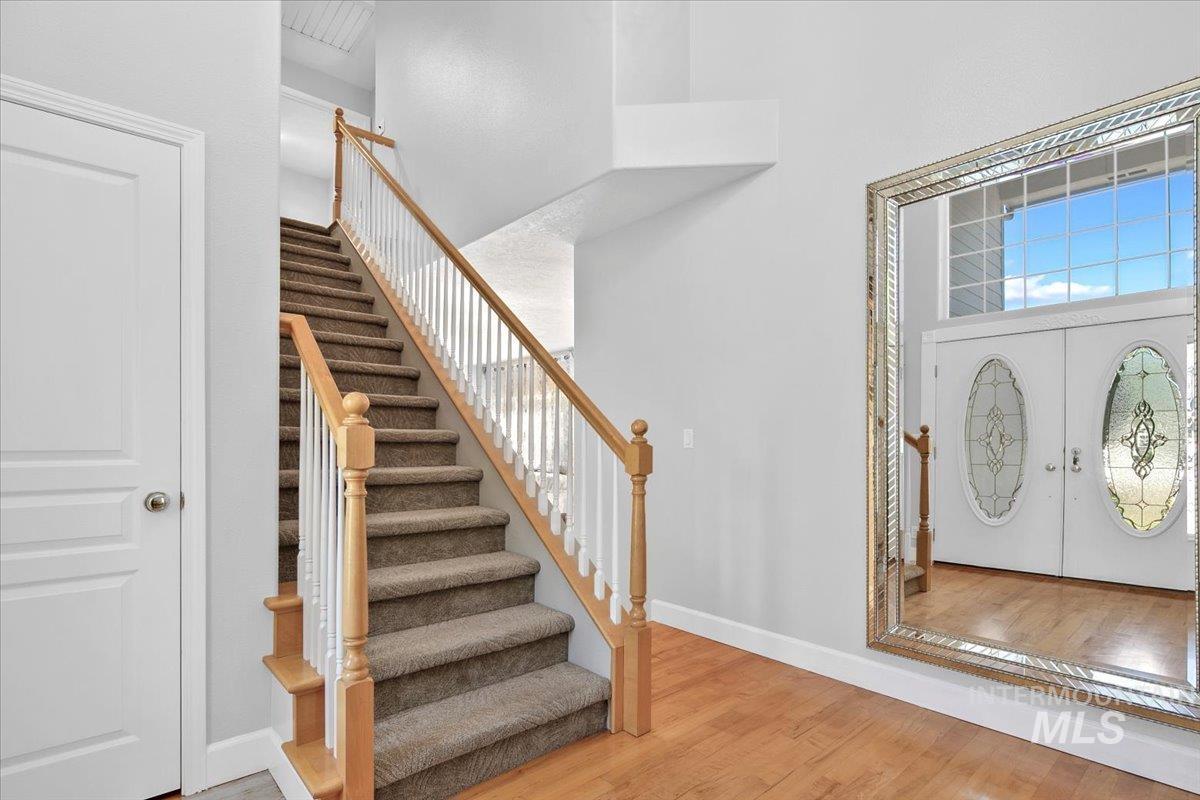 Entryway featuring wood finished floors and stairway