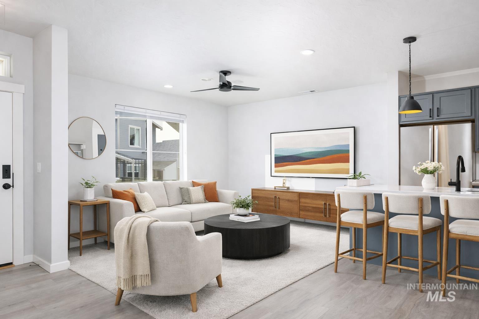 Living room featuring light wood-type flooring, a ceiling fan, and recessed lighting