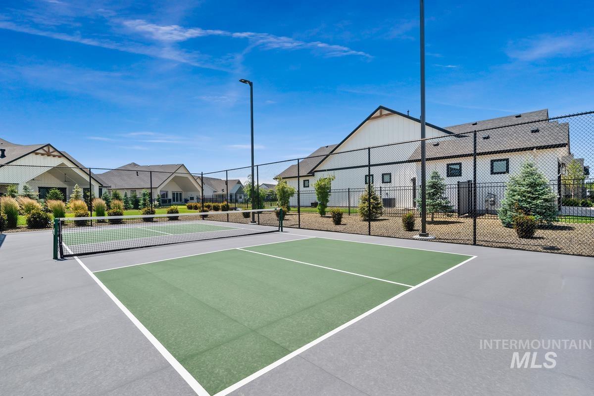 Surrounding community with a tennis court and a residential view