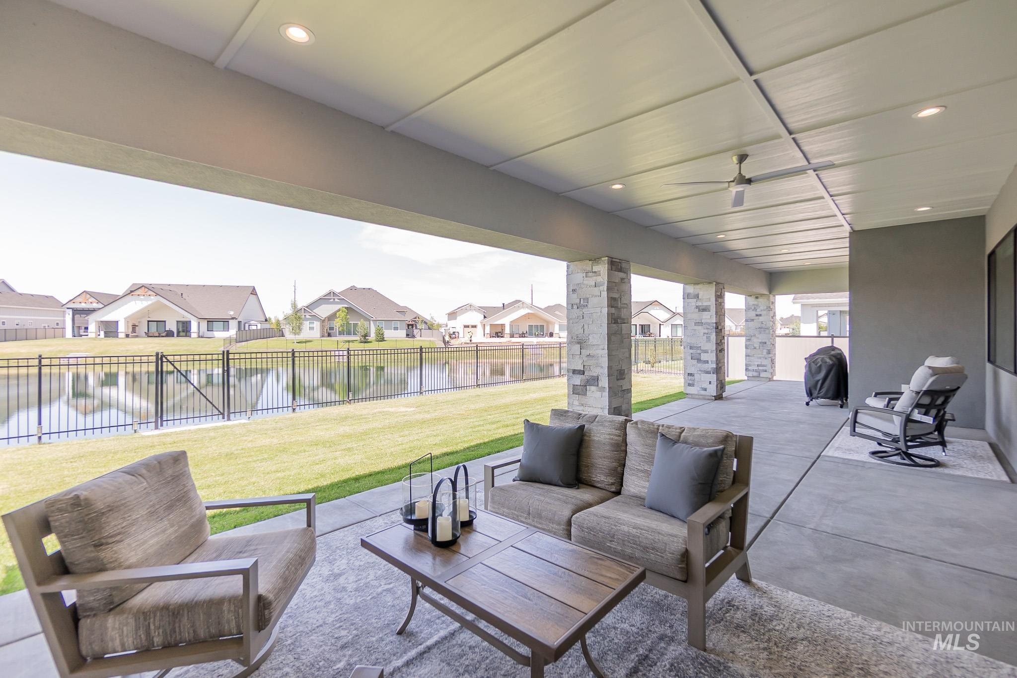 Fenced backyard with a patio area, outdoor lounge area, a residential view, and a water view