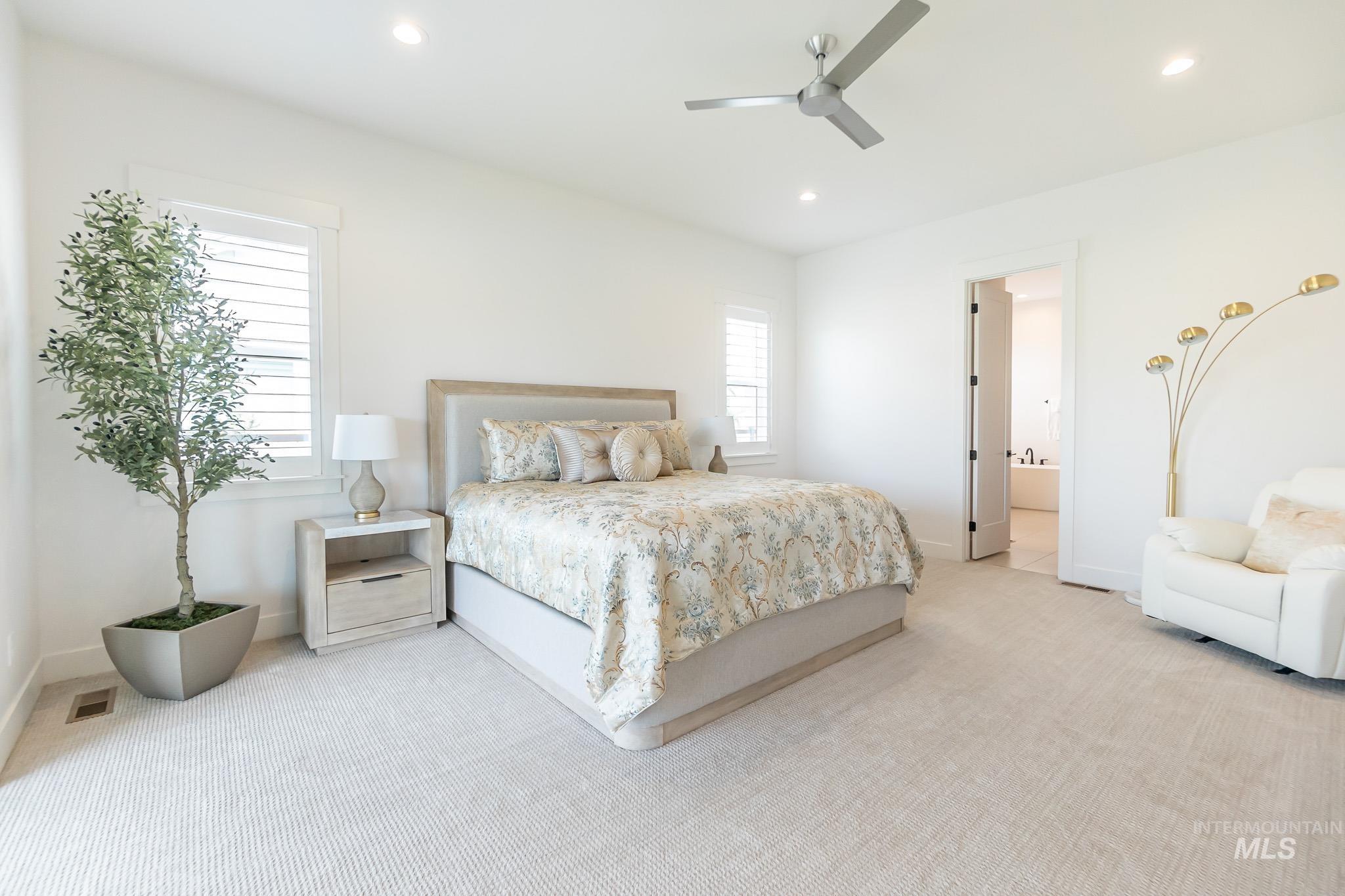 Bedroom featuring light colored carpet, recessed lighting, and a ceiling fan