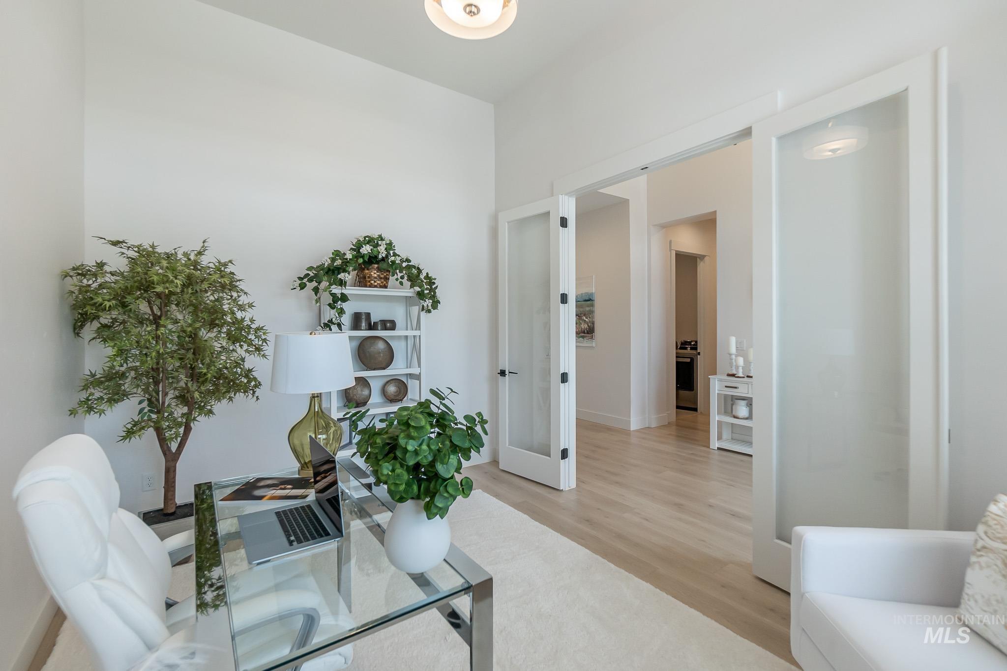 Office space with light wood-type flooring and french doors