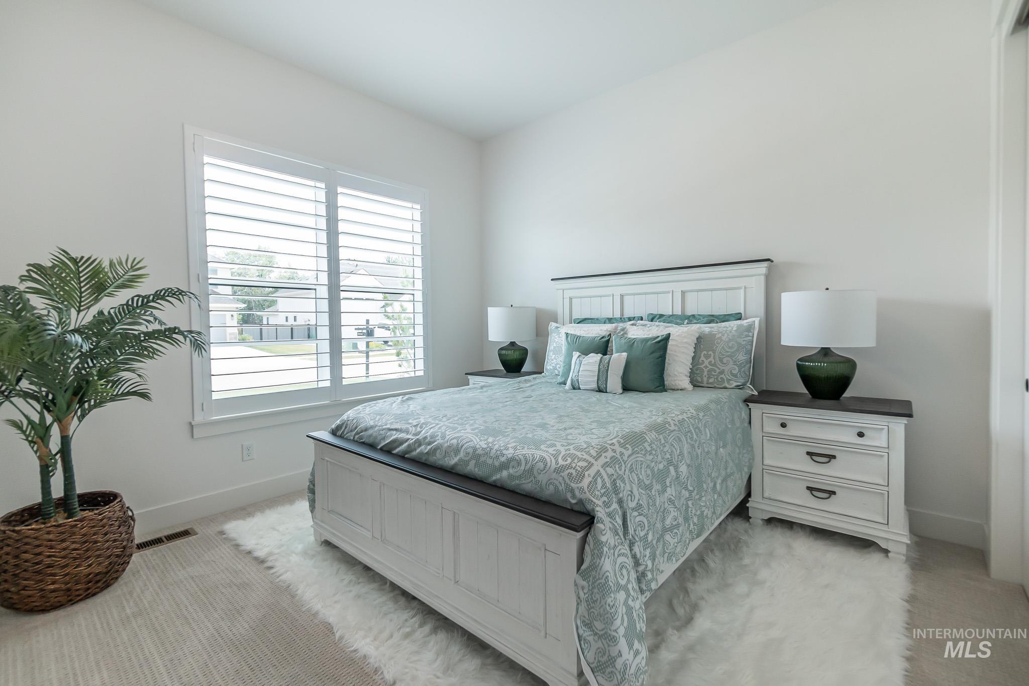 Bedroom featuring baseboards and light colored carpet