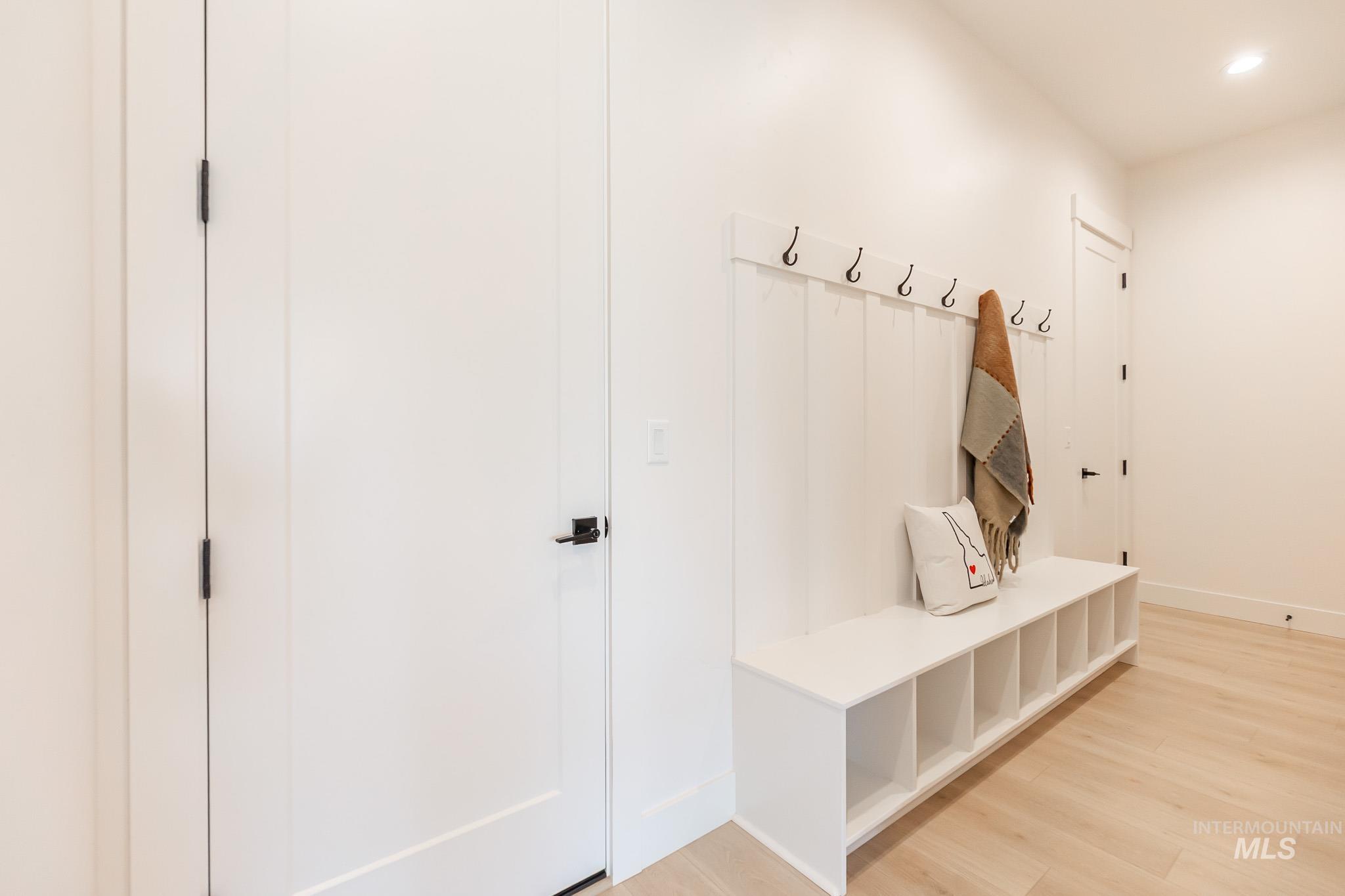 Mudroom with light wood-type flooring and recessed lighting