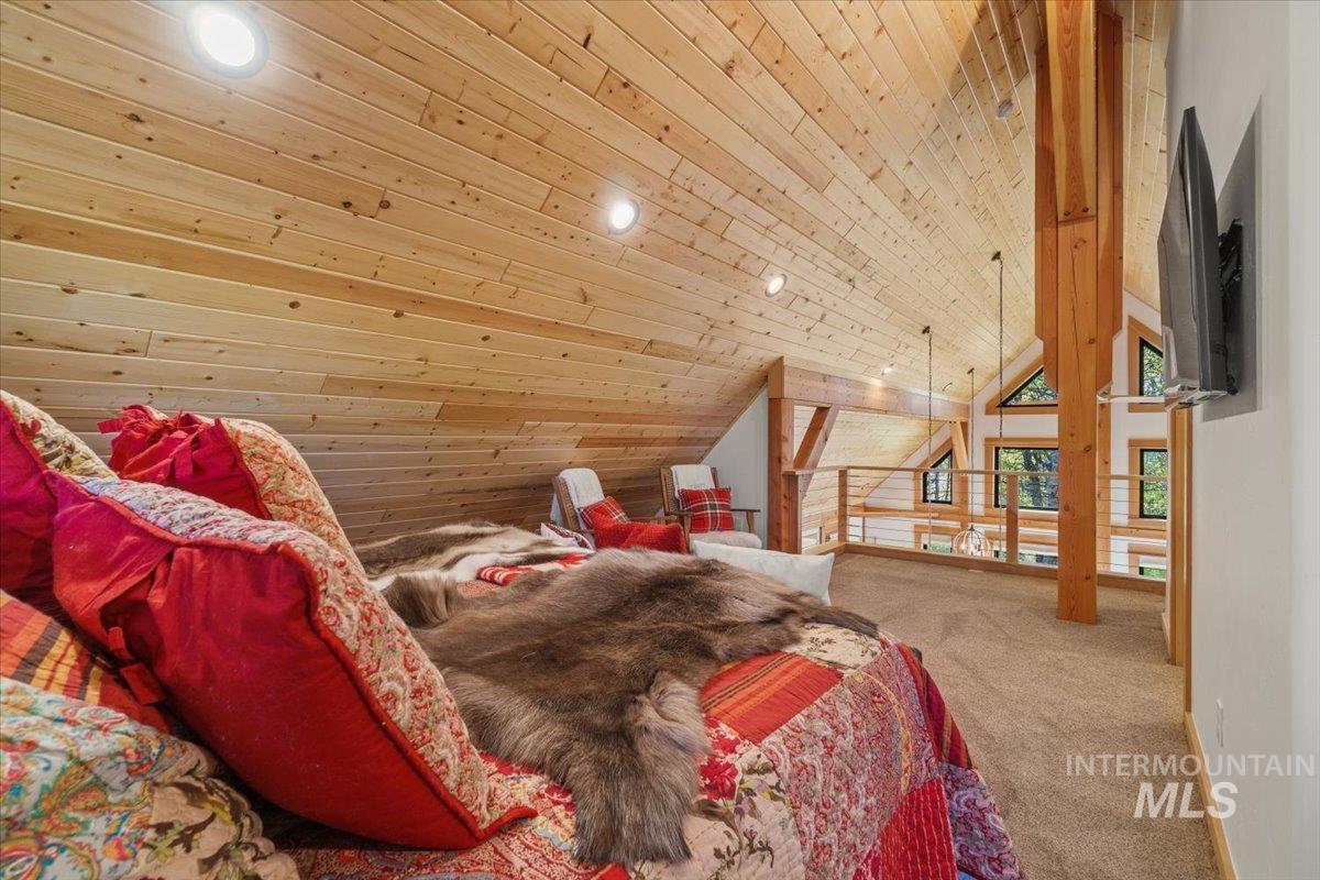 Carpeted bedroom featuring wooden ceiling, recessed lighting, and high vaulted ceiling