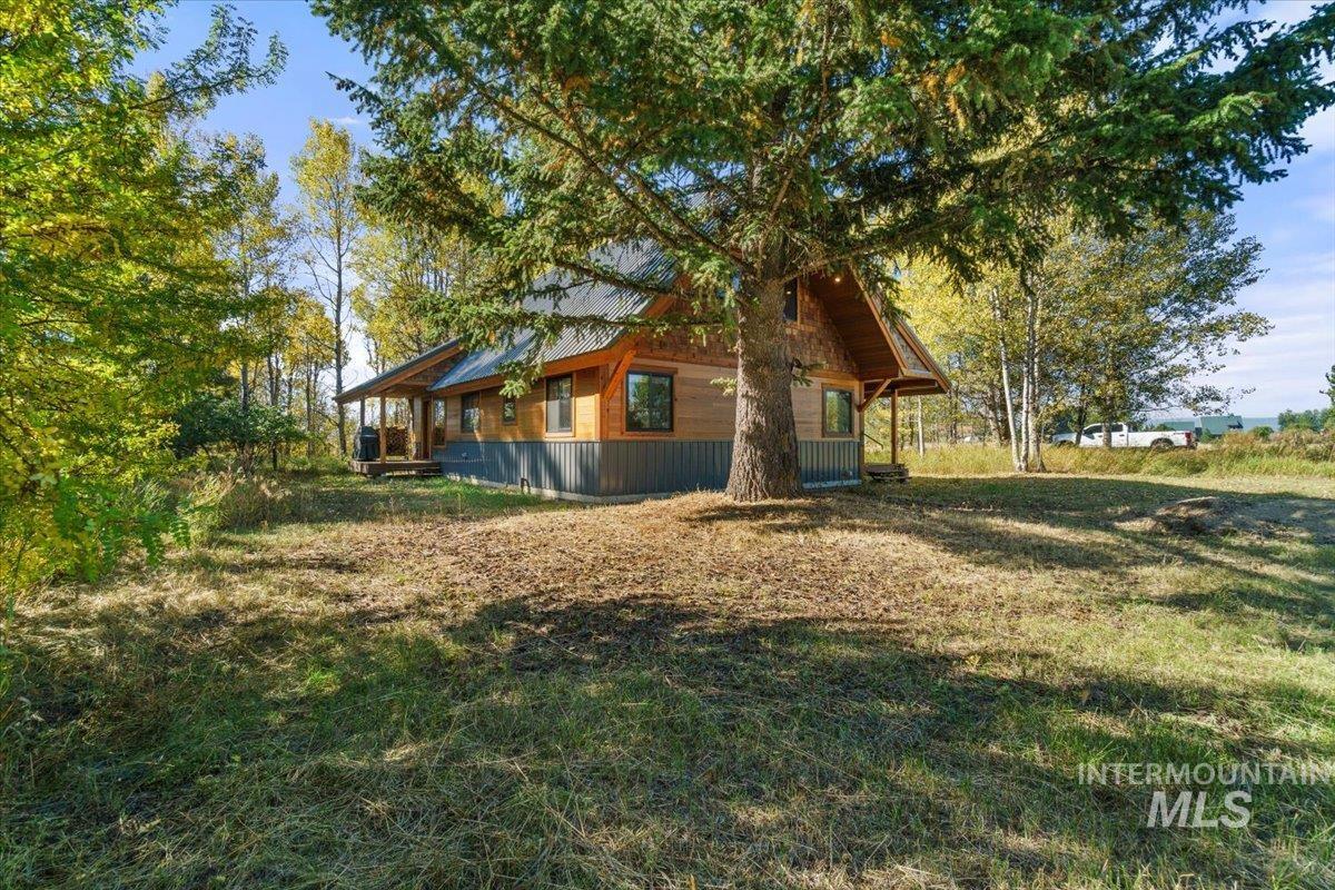 View of side of home featuring a lawn