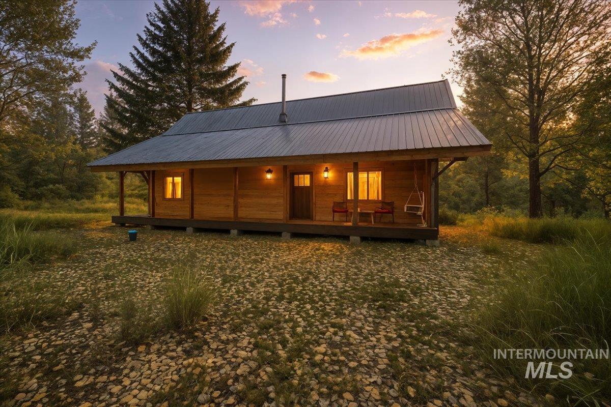 Back of property with a porch and a metal roof