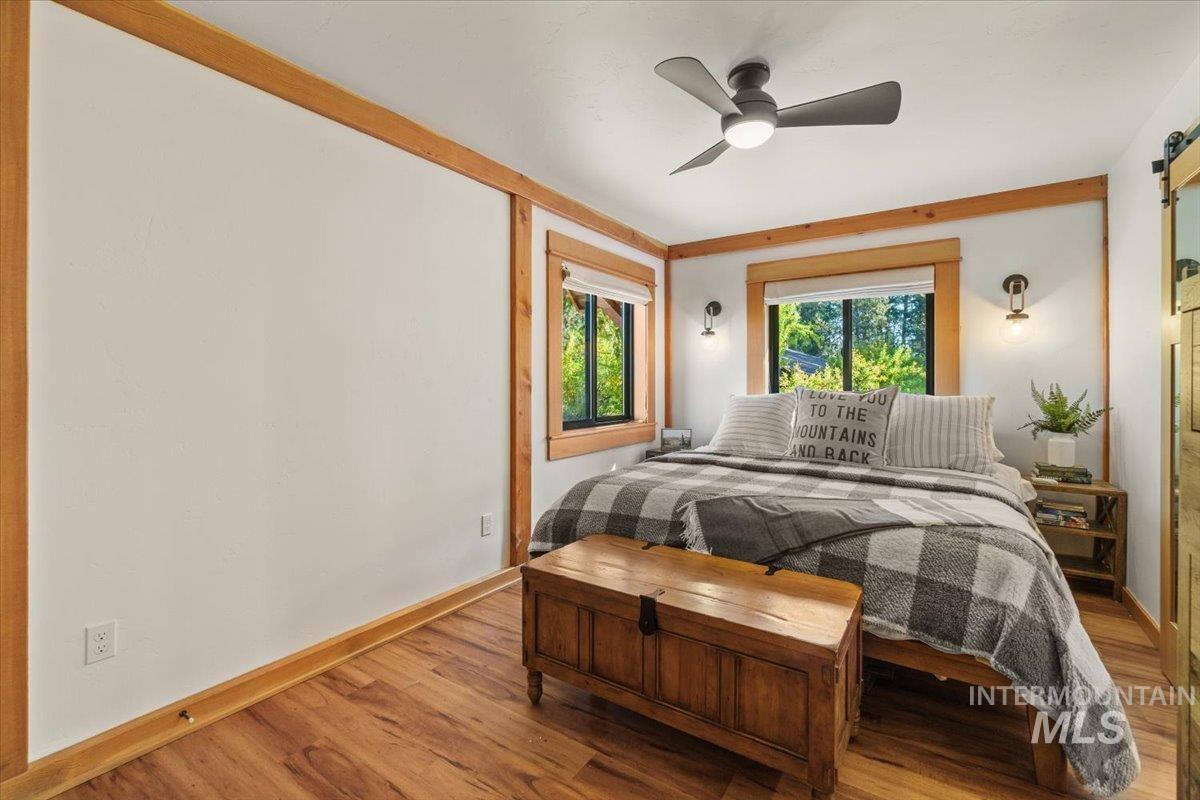 Bedroom featuring wood finished floors and ceiling fan