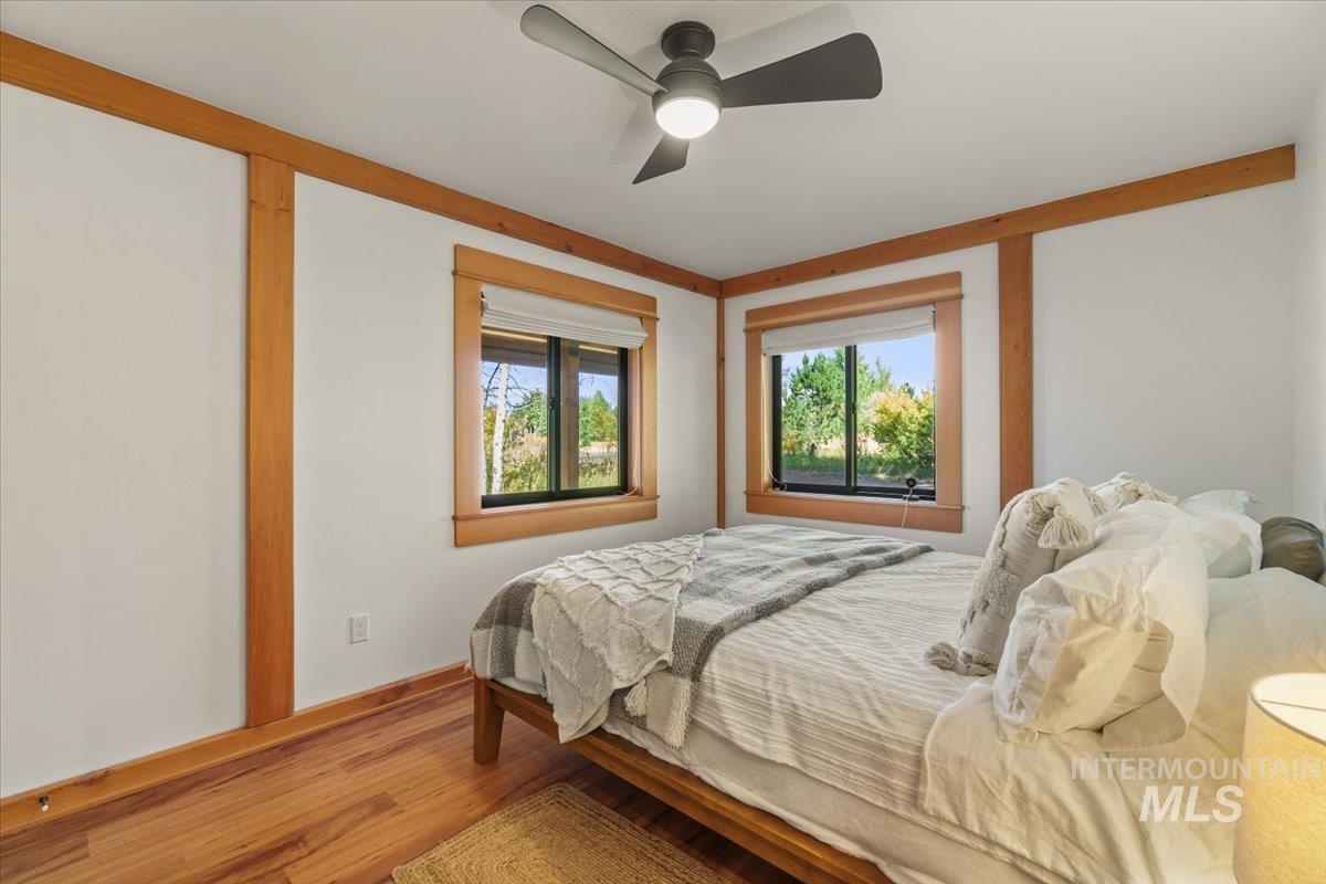 Bedroom featuring wood finished floors and a ceiling fan